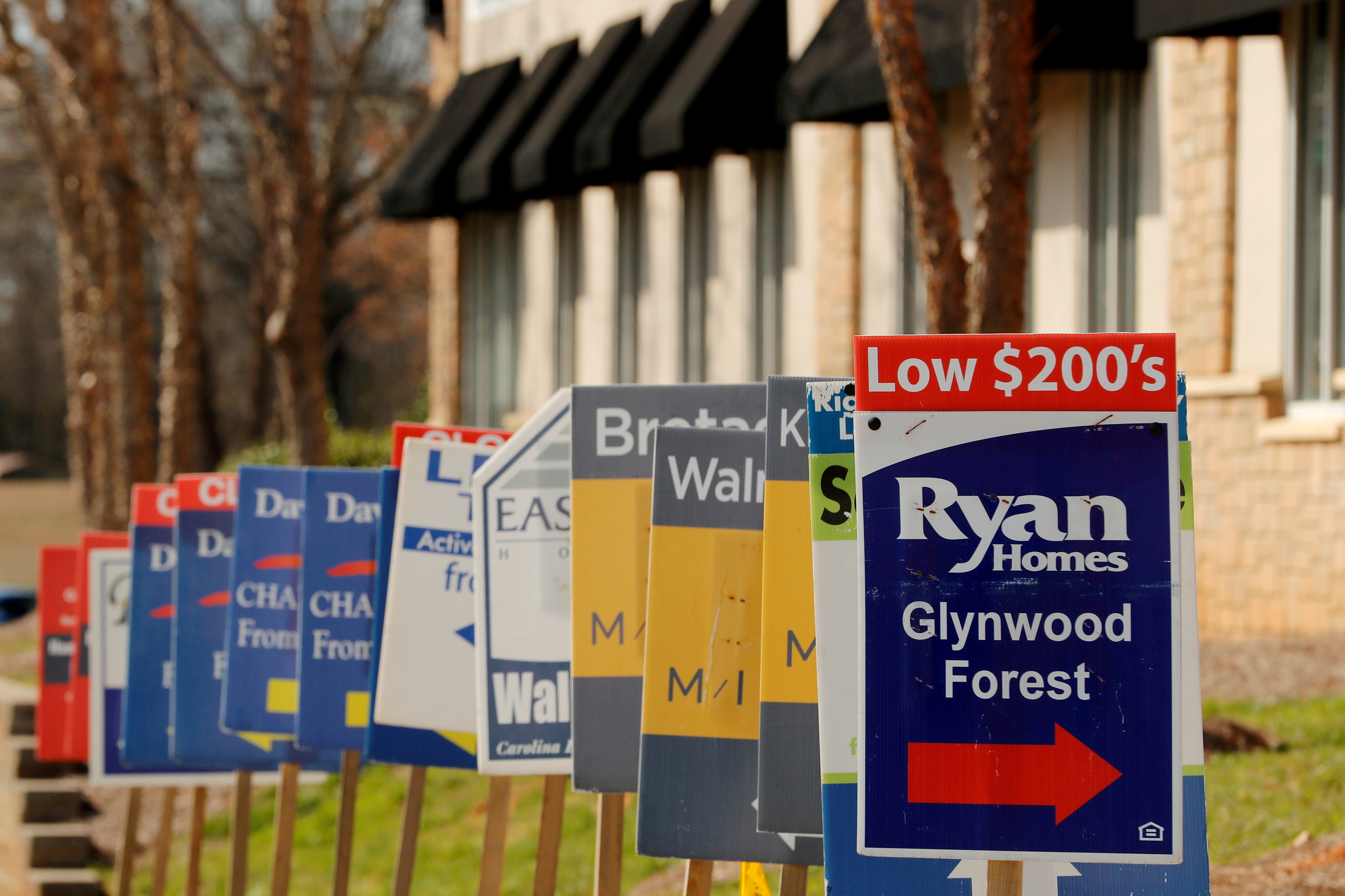 Real estate signs advertise new homes for sale in multiple new developments in York County, South Carolina, U.S., February 29, 2020. REUTERS/Lucas Jackson/File Photo