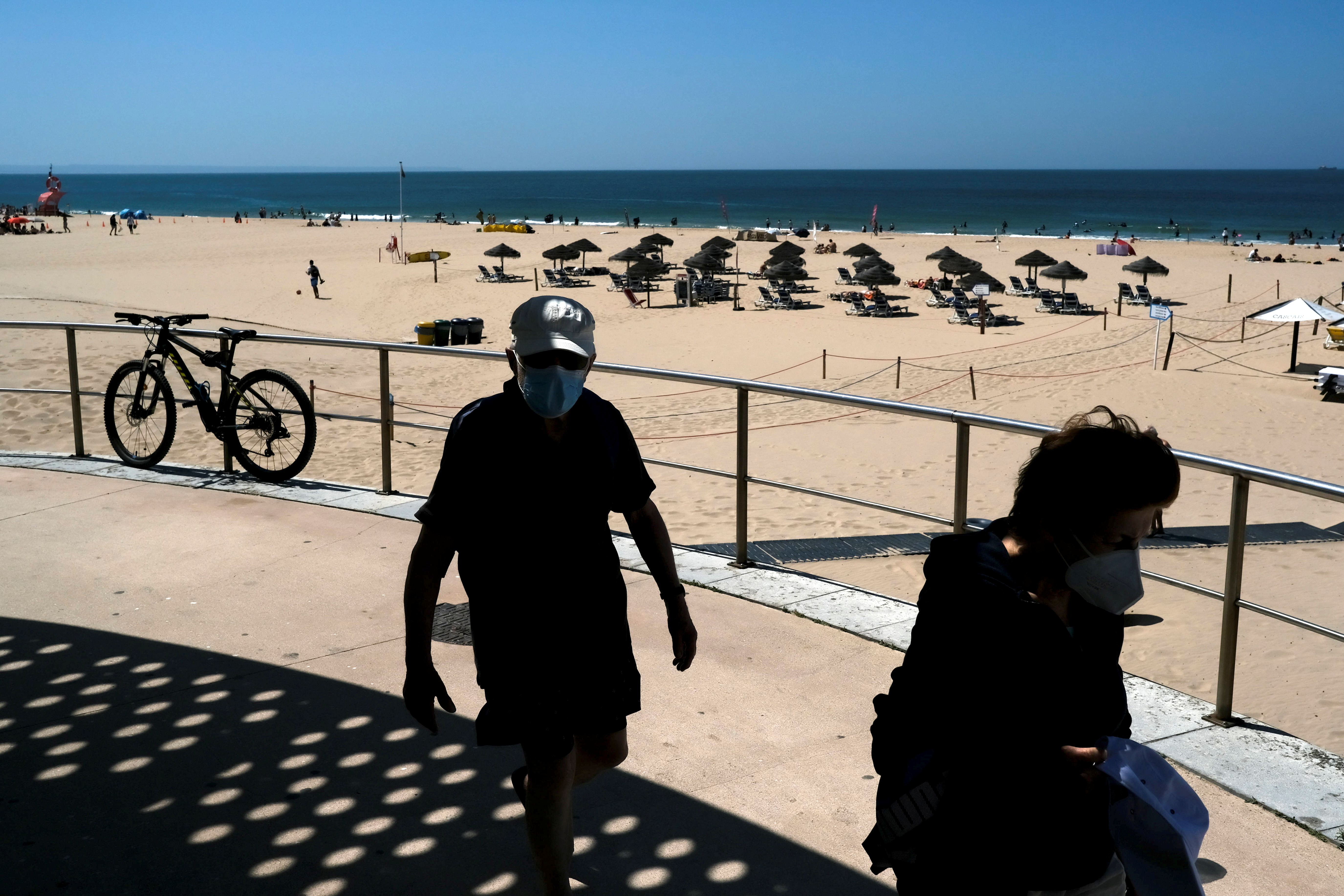 People walk at Carcavelos beach amid COVID-19 pandemic, in Cascais