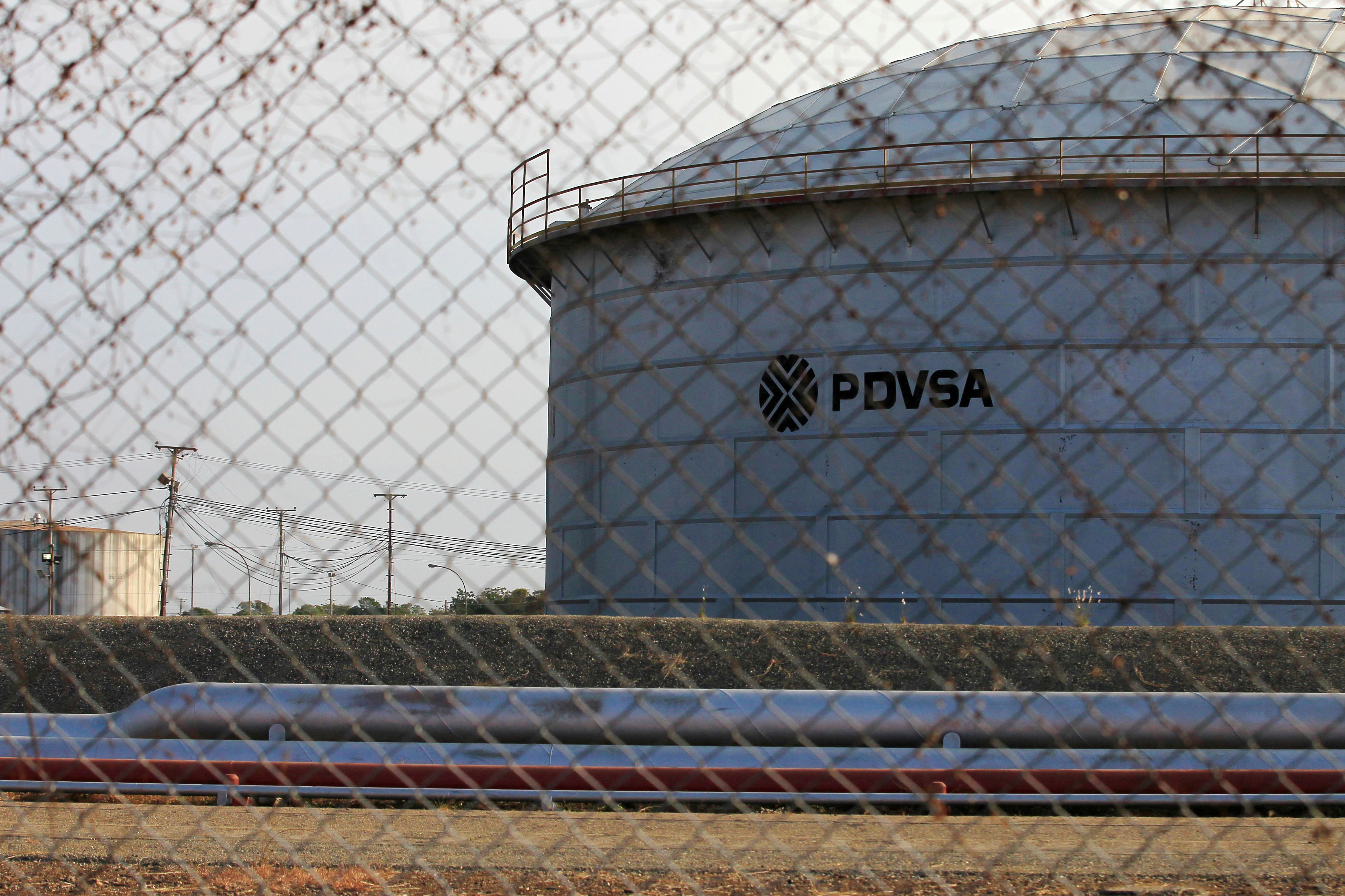 The corporate logo of state oil company PDVSA is seen on a tank at an oil facility in Lagunillas