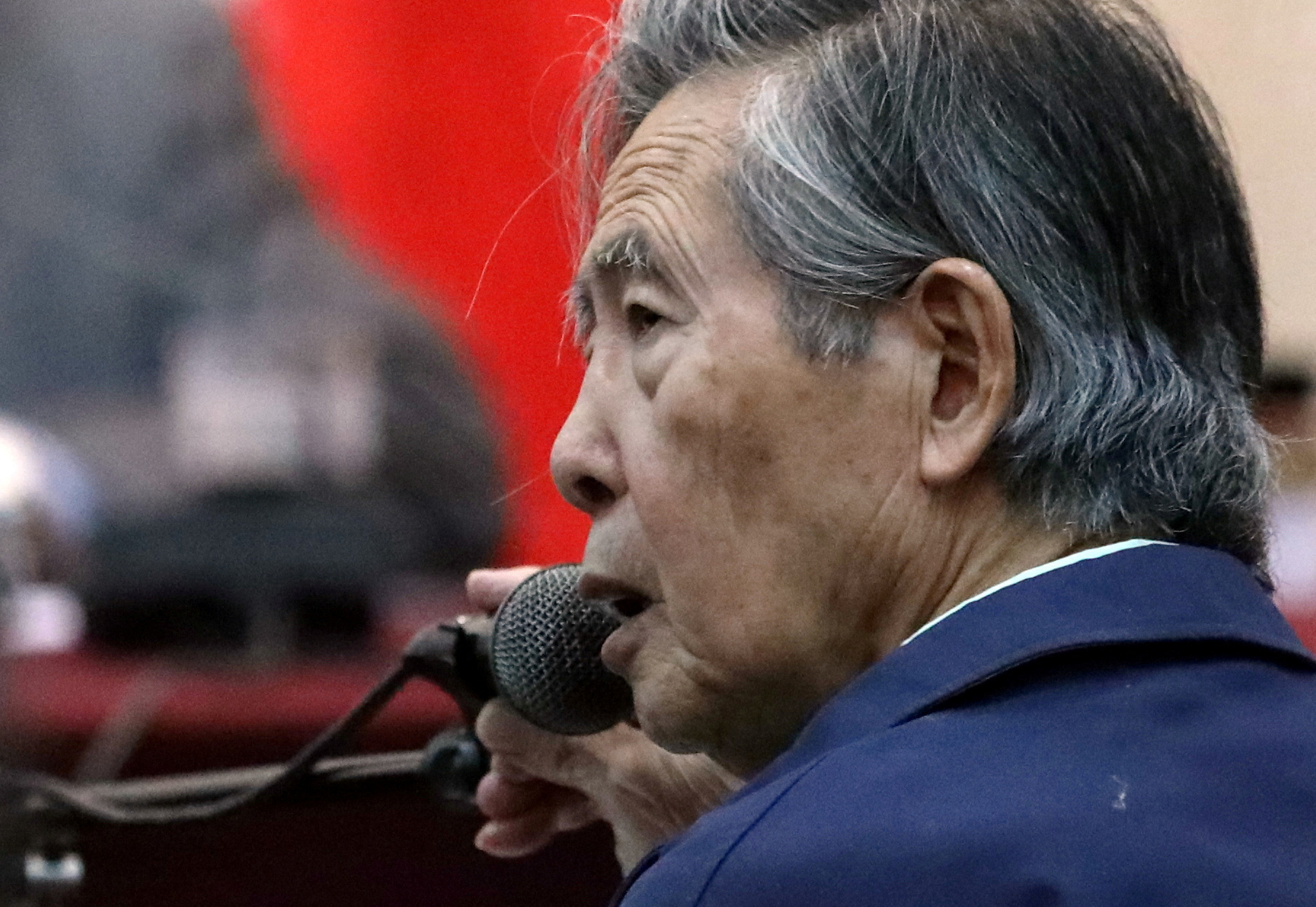 Former President of Peru Alberto Fujimori attends a trial as a witness at the navy base in Callao