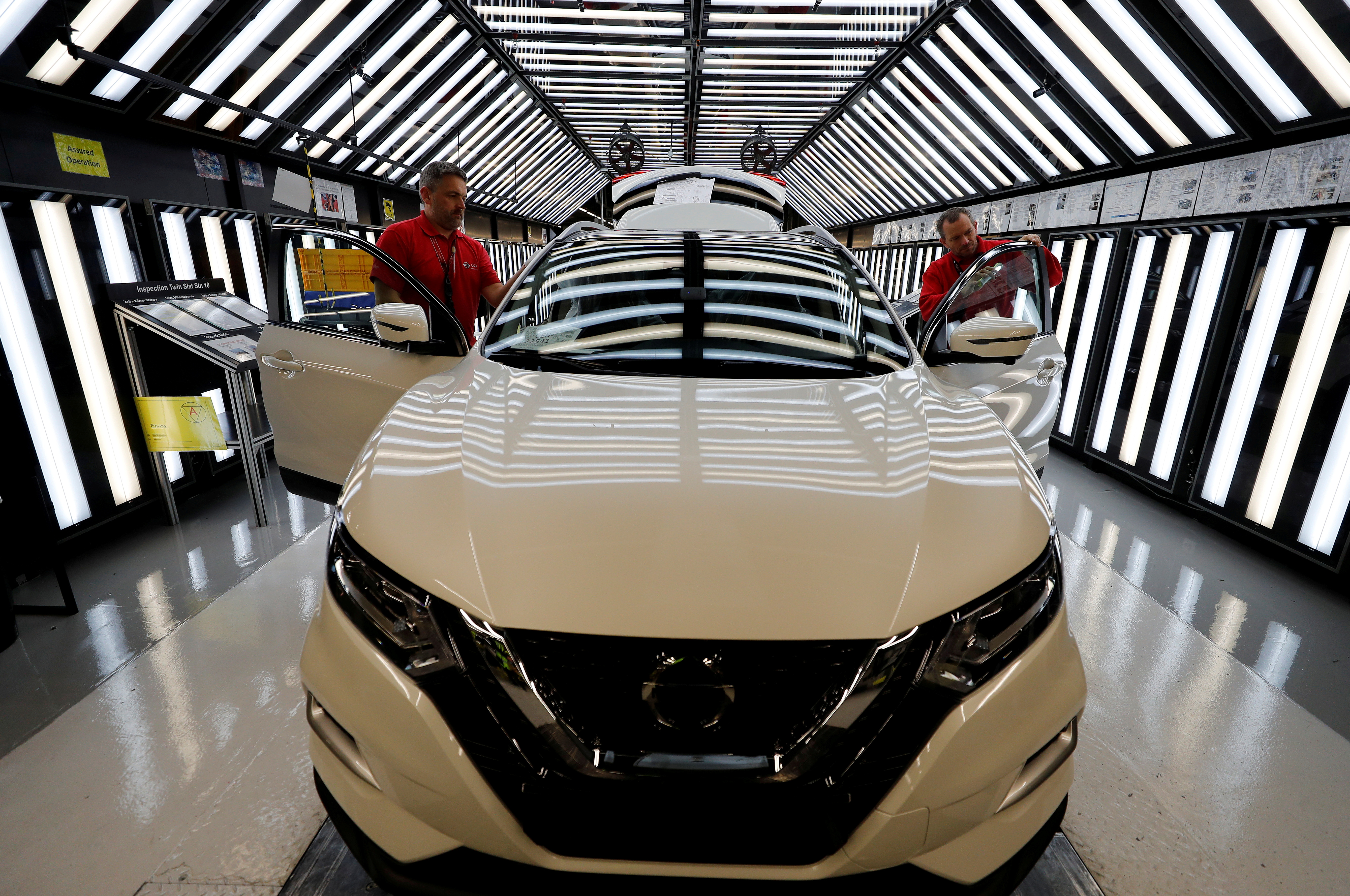 Workers are seen on the production line at Nissan's car plant in Sunderland Britain