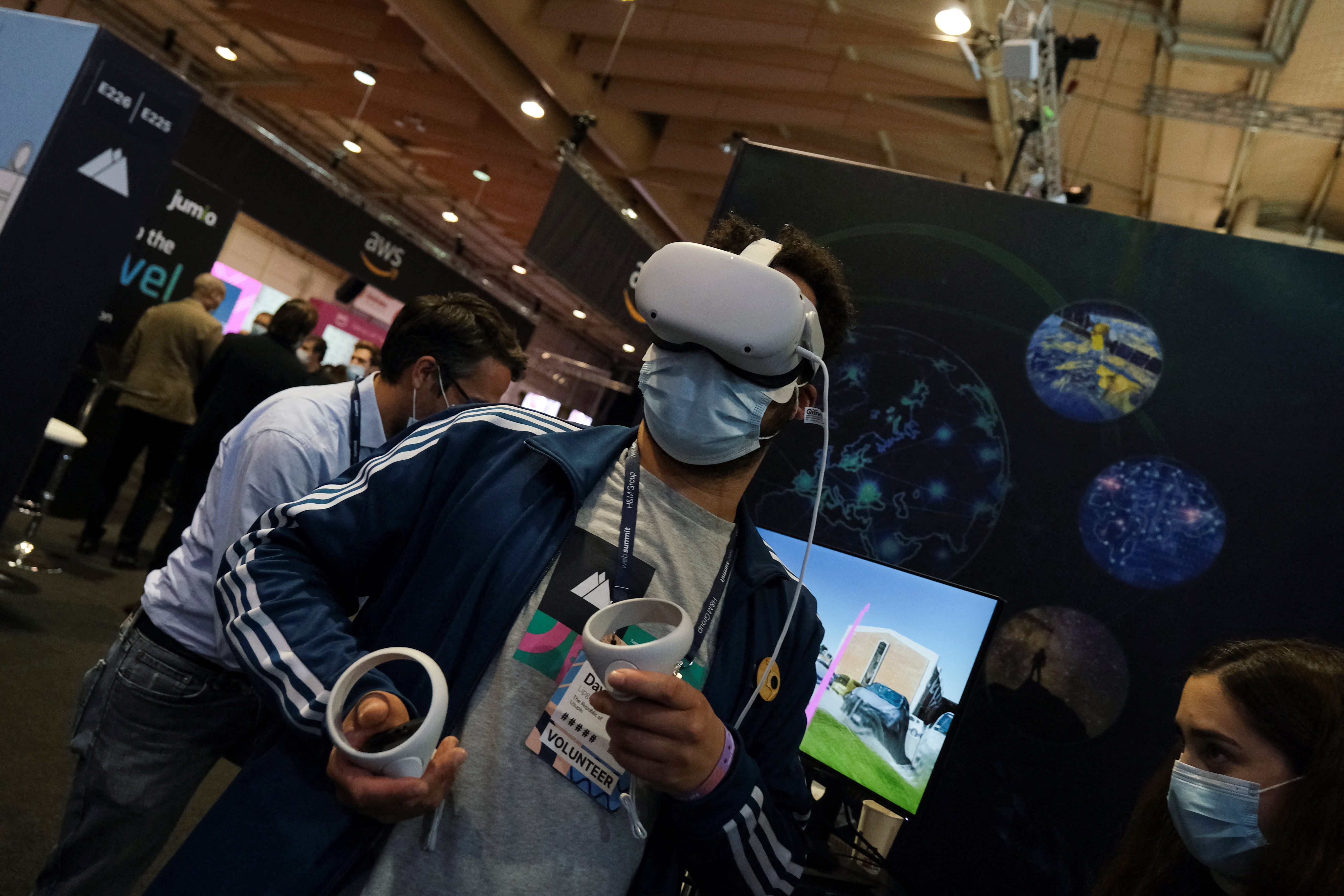A person wears virtual reality goggles at the European Space Agency (ESA) stand in the Web Summit, in Lisbon