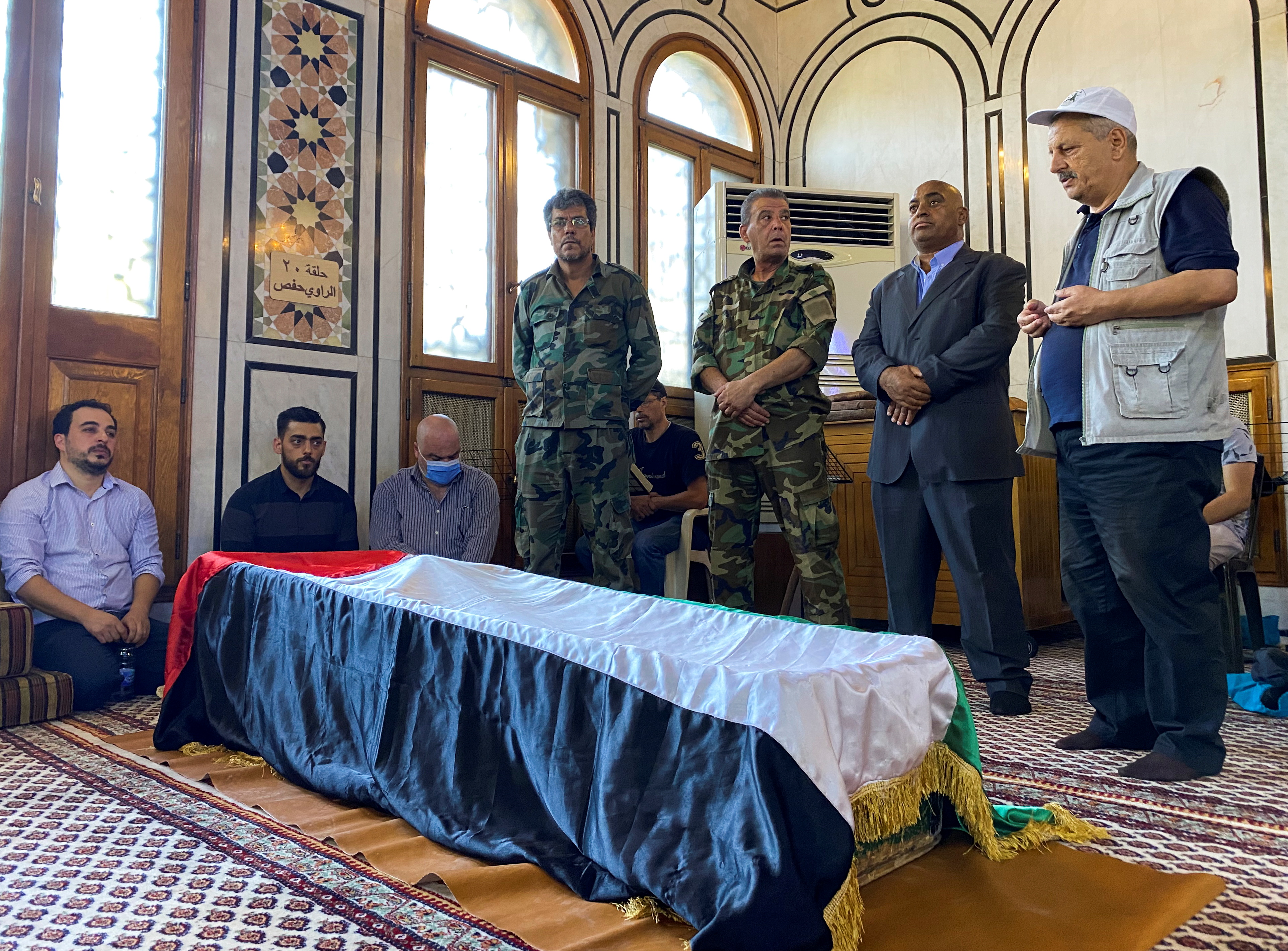 Mourners stand near the coffin of Ahmed Jibril, founder of pro-Syrian Palestinian guerrilla faction, during his funeral at a mosque in Damascus