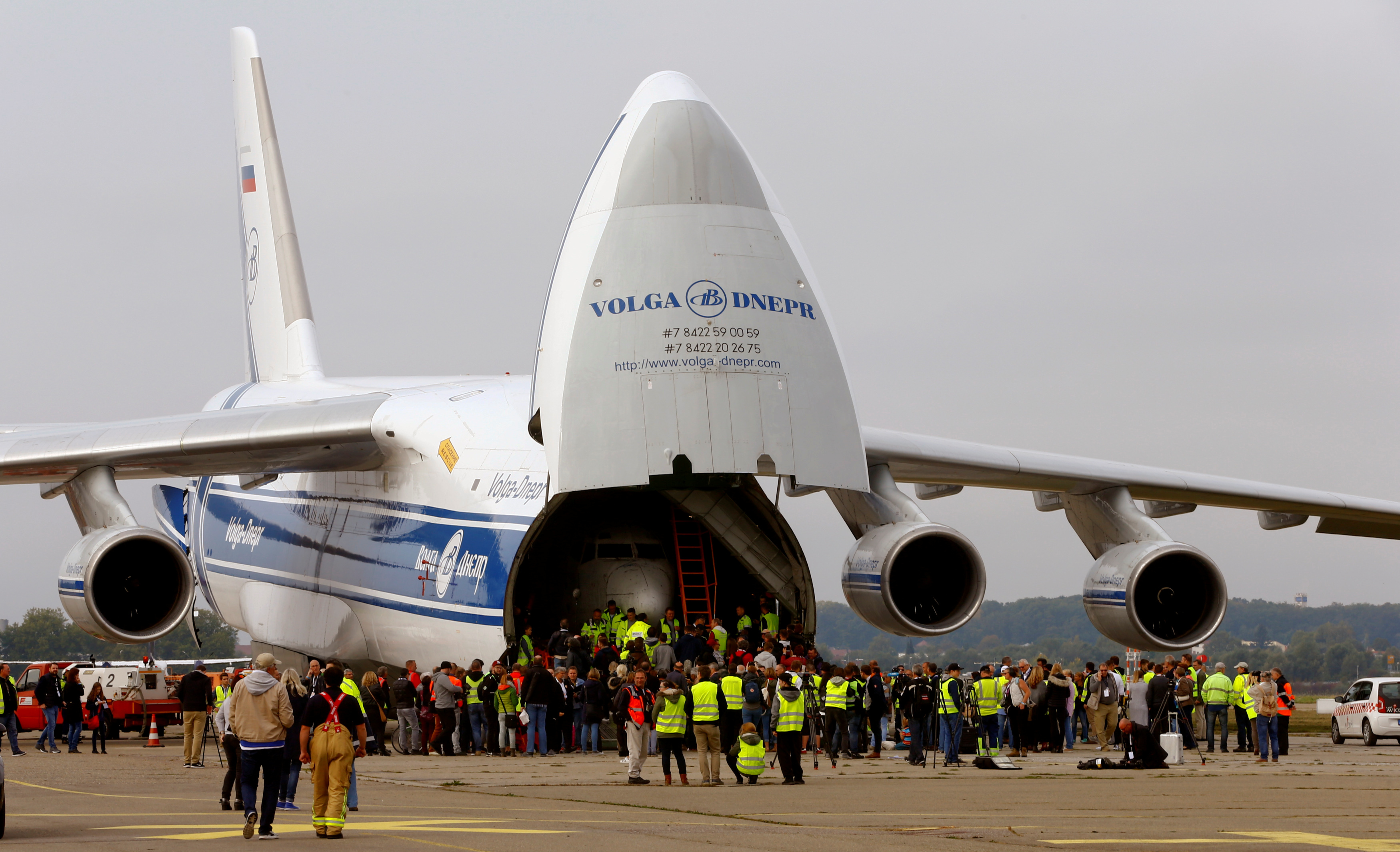 People stand in front of a Russian Volga-Dnepr Airlines Antonov An-124 aircraft transporting the fuselage of a Lufthansa Boeing 737-200, also known as Landshut, in Friedrichshafen
