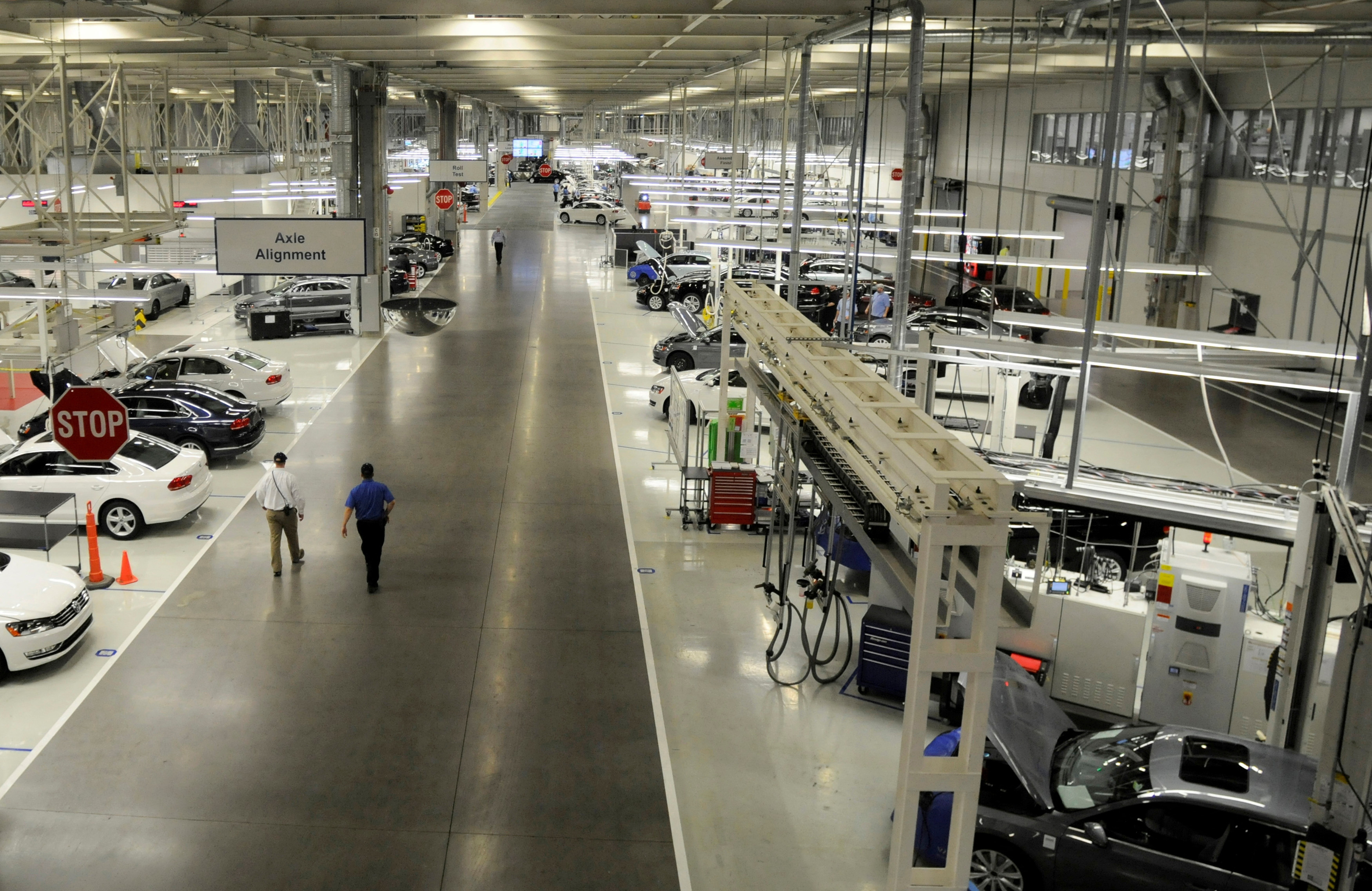 Two Volkswagen employees walk through the axle alignment department in Chattanooga Tennessee