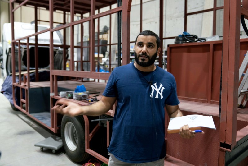Mohammed al-Blushi speaks at his factory for manufacturing food trucks in Kuwait