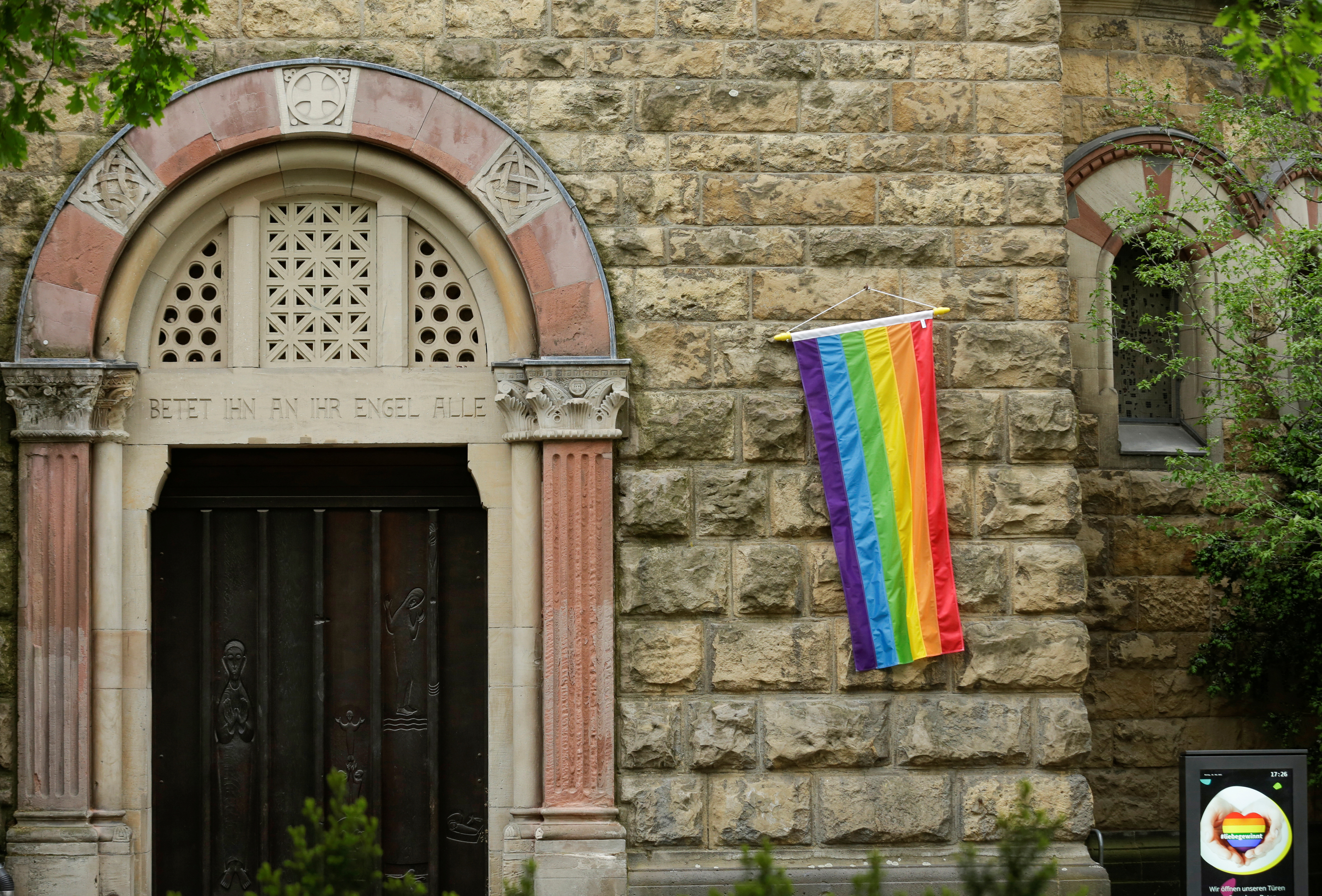 A rainbow flag is seen on the wall of a Catholic church in Cologne