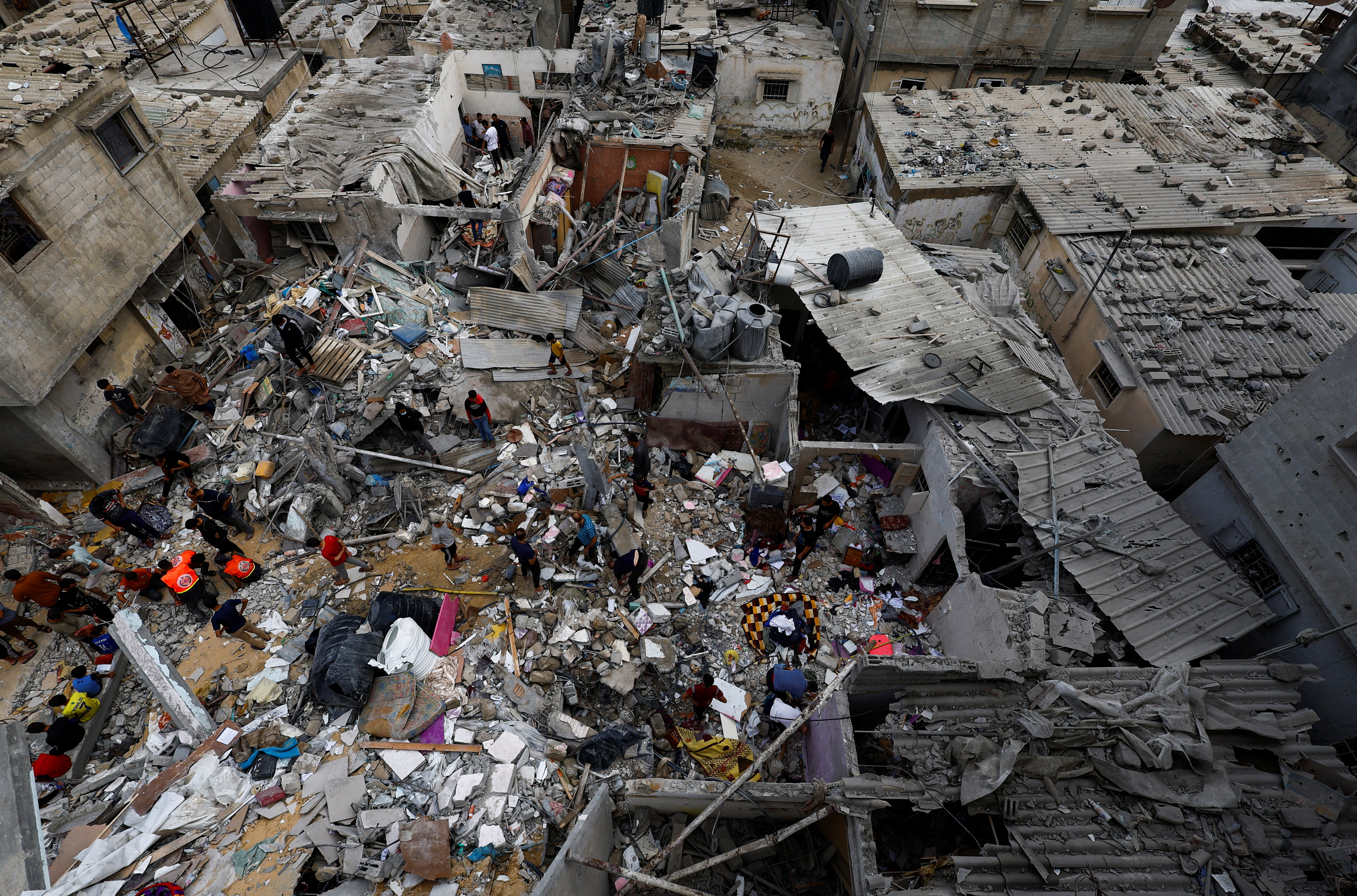 People check the damage at the site of Israeli strikes on houses in Khan Younis in the southern Gaza Strip