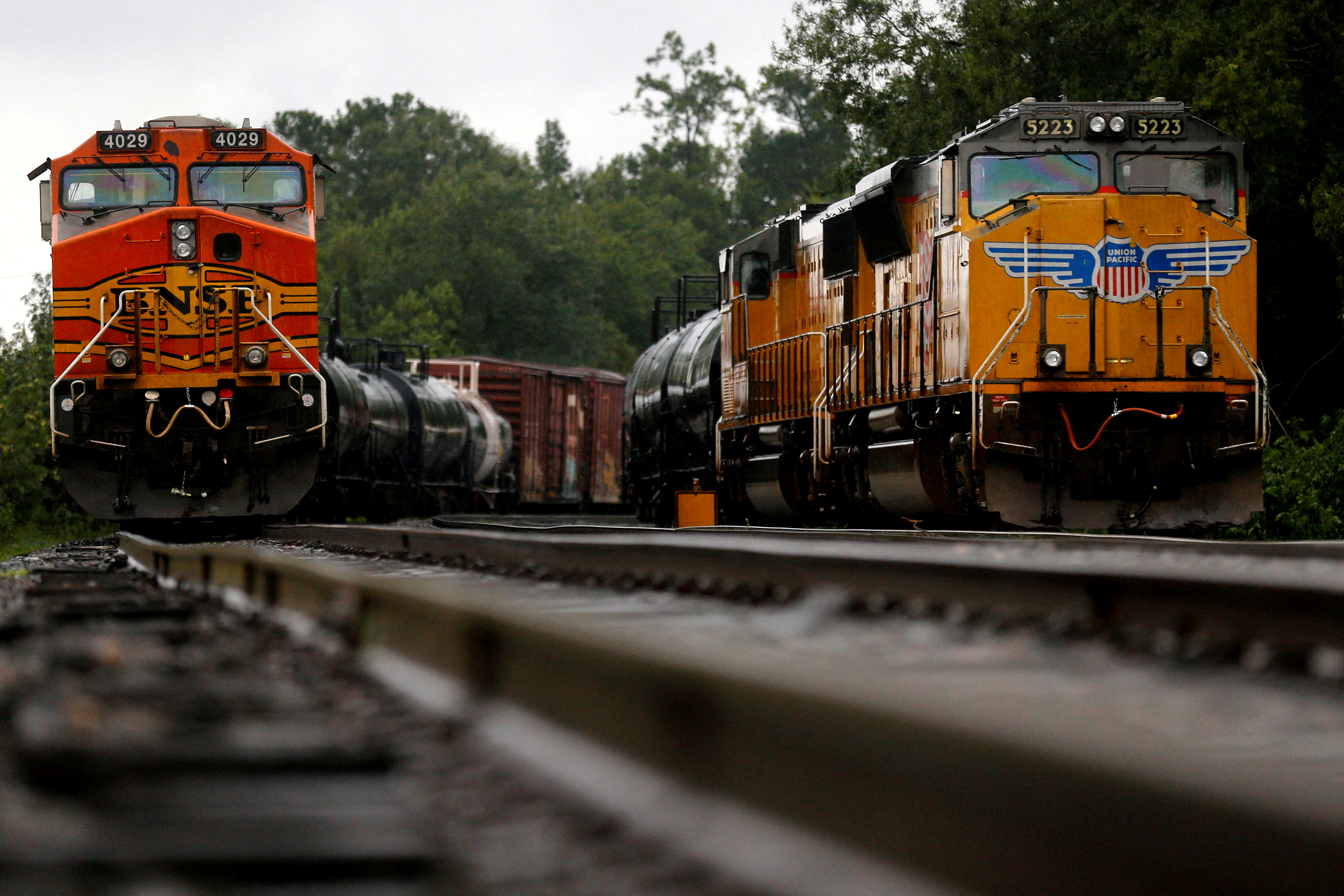 BNSF and Union Pacific train engines stand still on tracks due to flooding on the line from Tropical Storm Harvey in Orange
