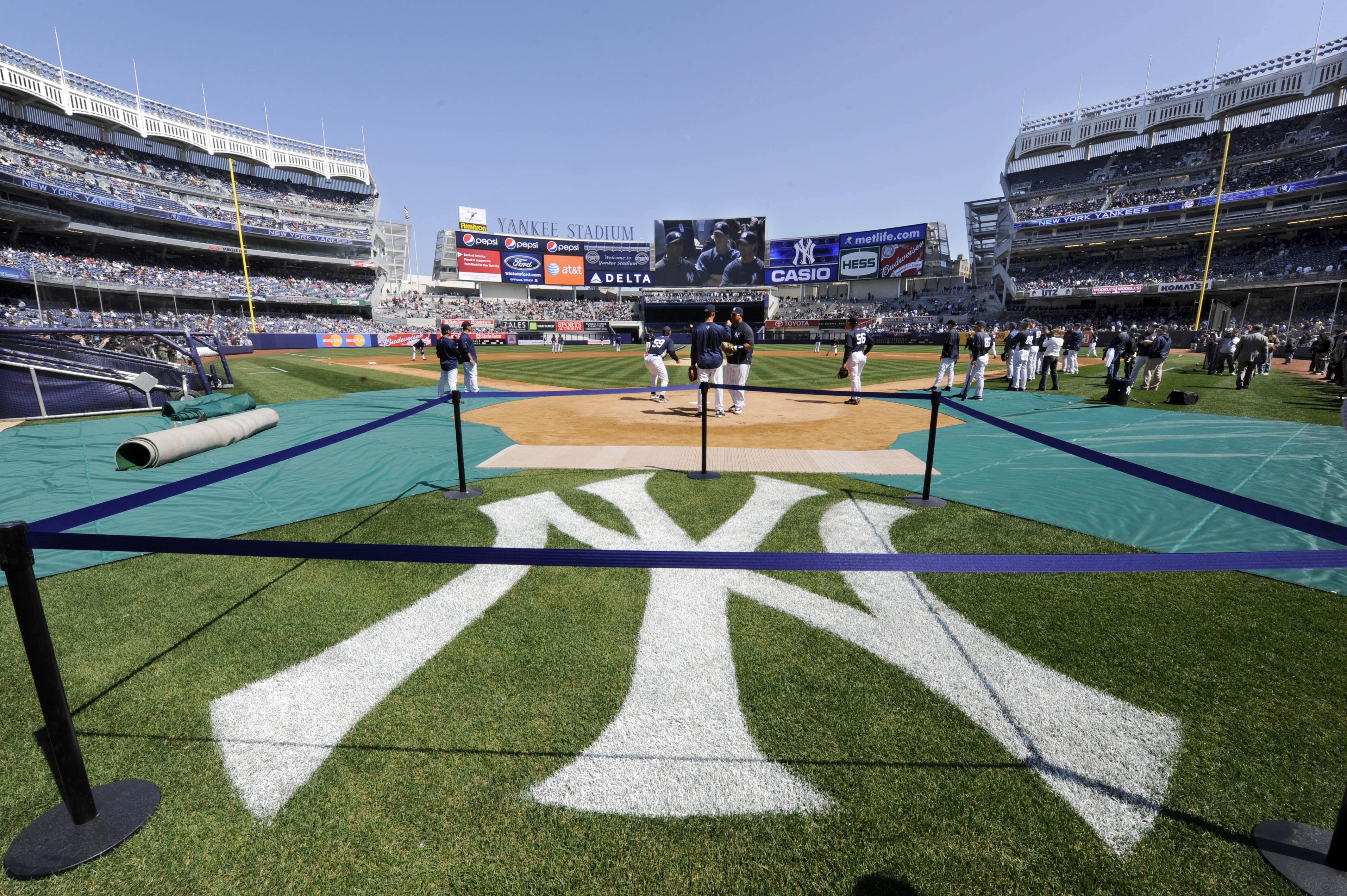 The traditional logo is painted on the grass as the New York Yankees workout in New York