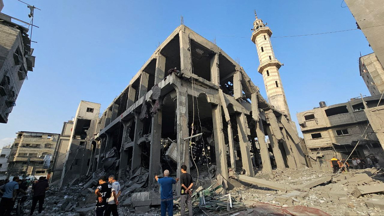 Palestinians inspect the remains of a mosque destroyed in Israeli strikes, in the northern Gaza Strip