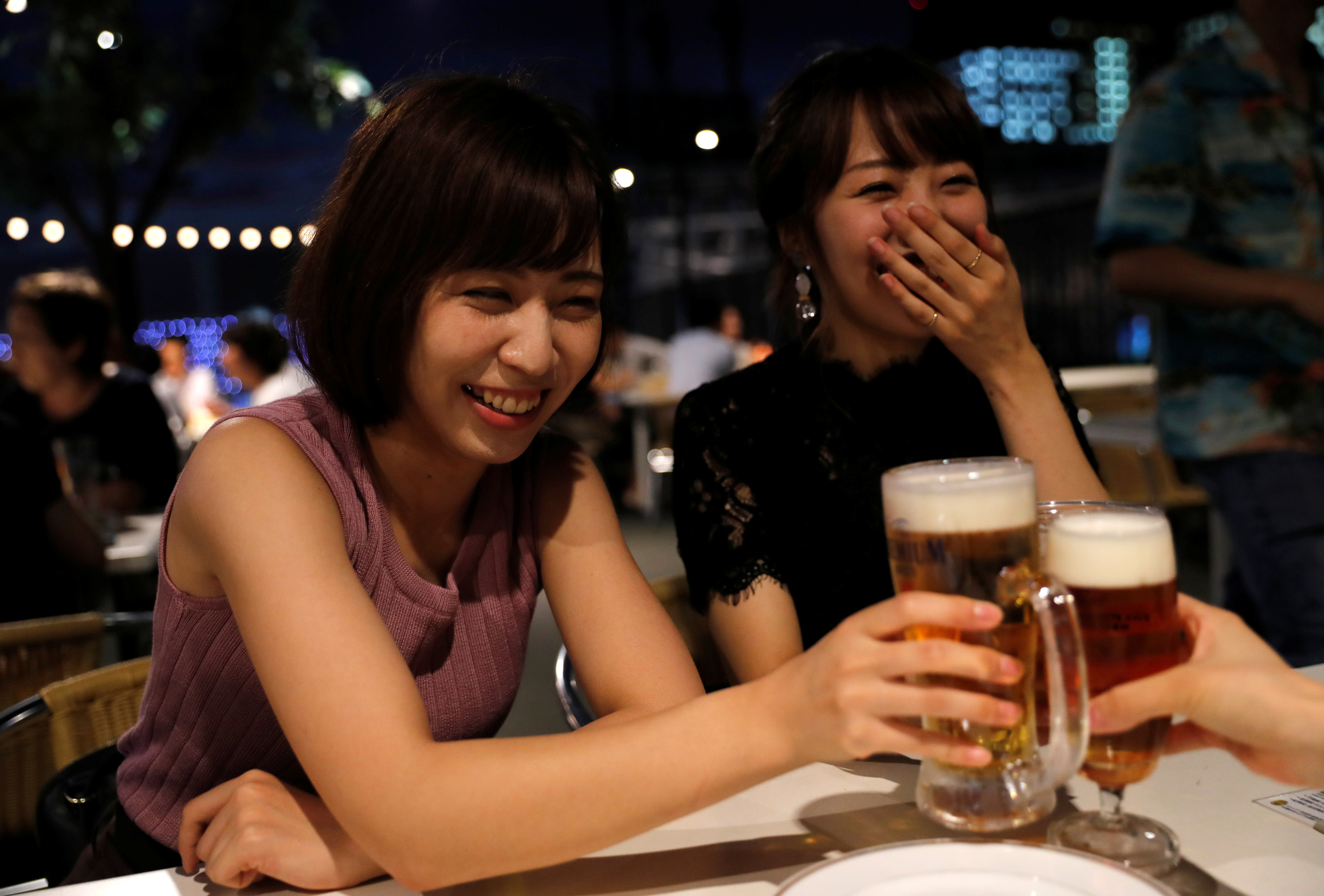 Female customers toast with beer at a restaurant in Tokyo