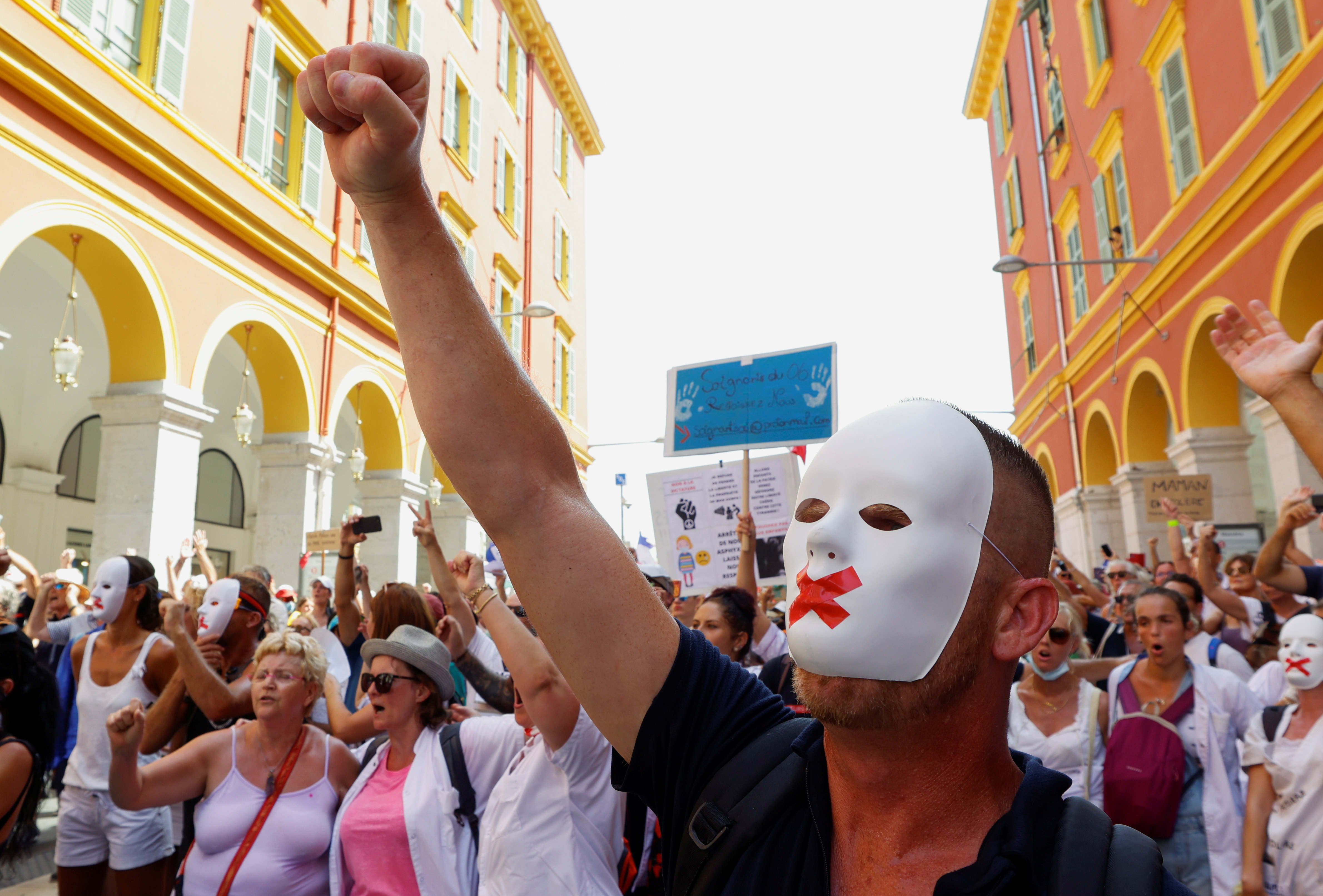 Protesters march against the coronavirus disease (COVID-19) vaccination and the use of health passes to restaurants, bars, trains and planes in Nice, France, August 14, 2021. REUTERS/Eric Gaillard