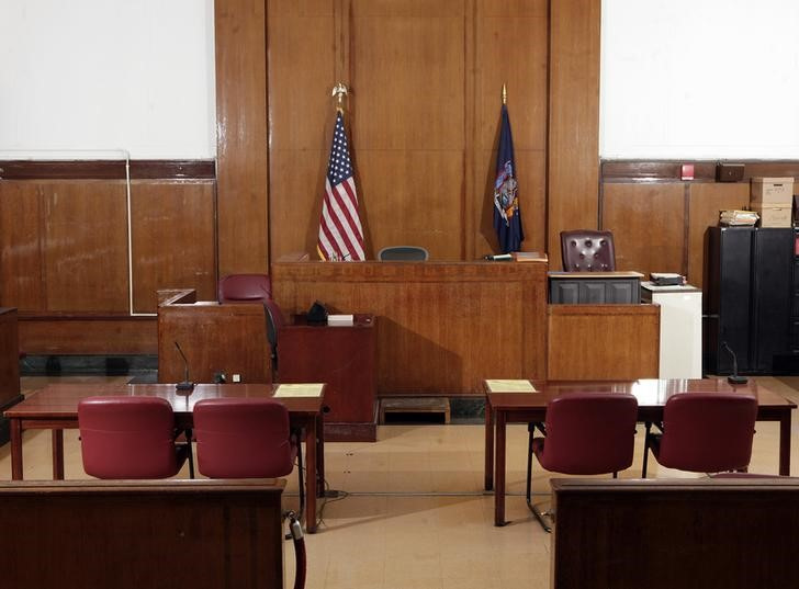 The witness stand (rear L) and the judge's chair (rear C), face towards the defense table (L) and prosecution table (R), in Part 31, Room 1333 of the New York State Supreme Court, Criminal Term at 100 Centre Street, in New York