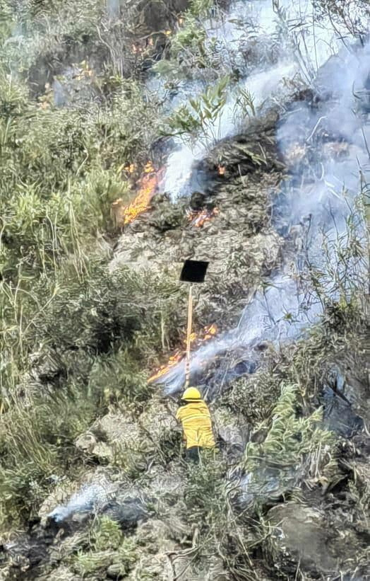Emergency personnel work to put out a forest fire in Machu Picchu