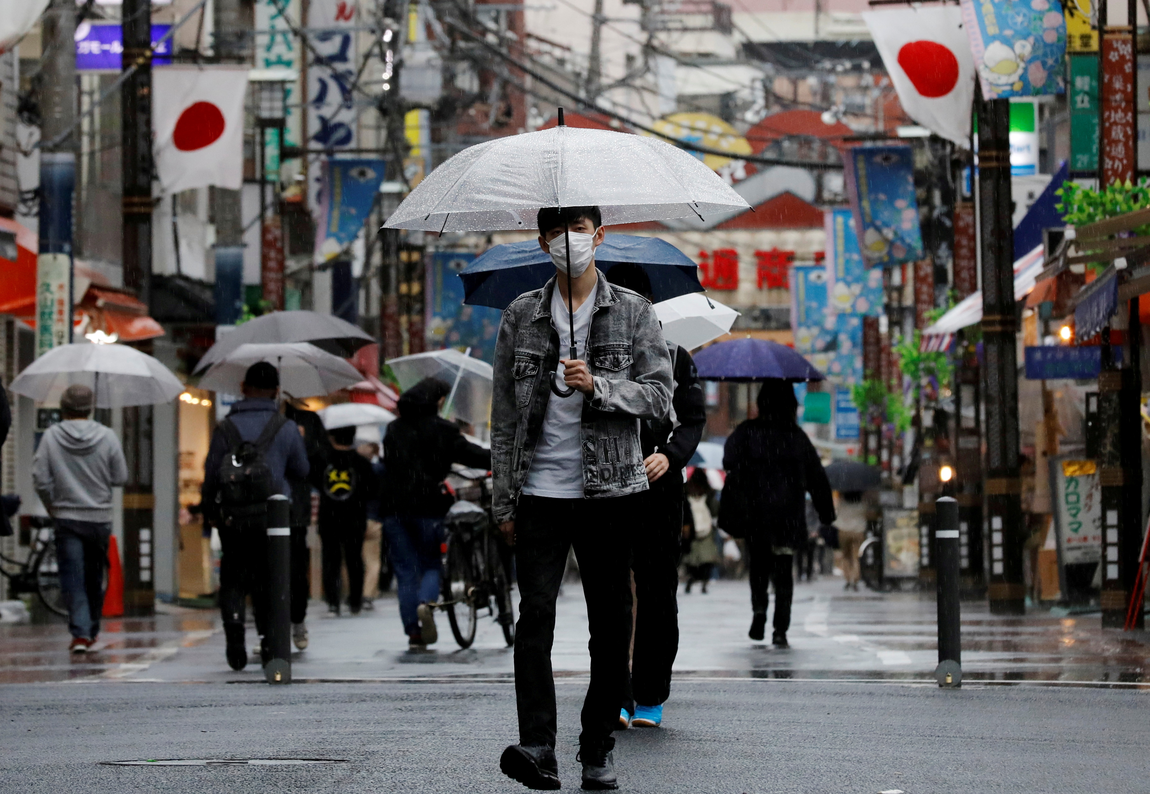 FILE PHOTO: A man walks at a local shopping street in Tokyo