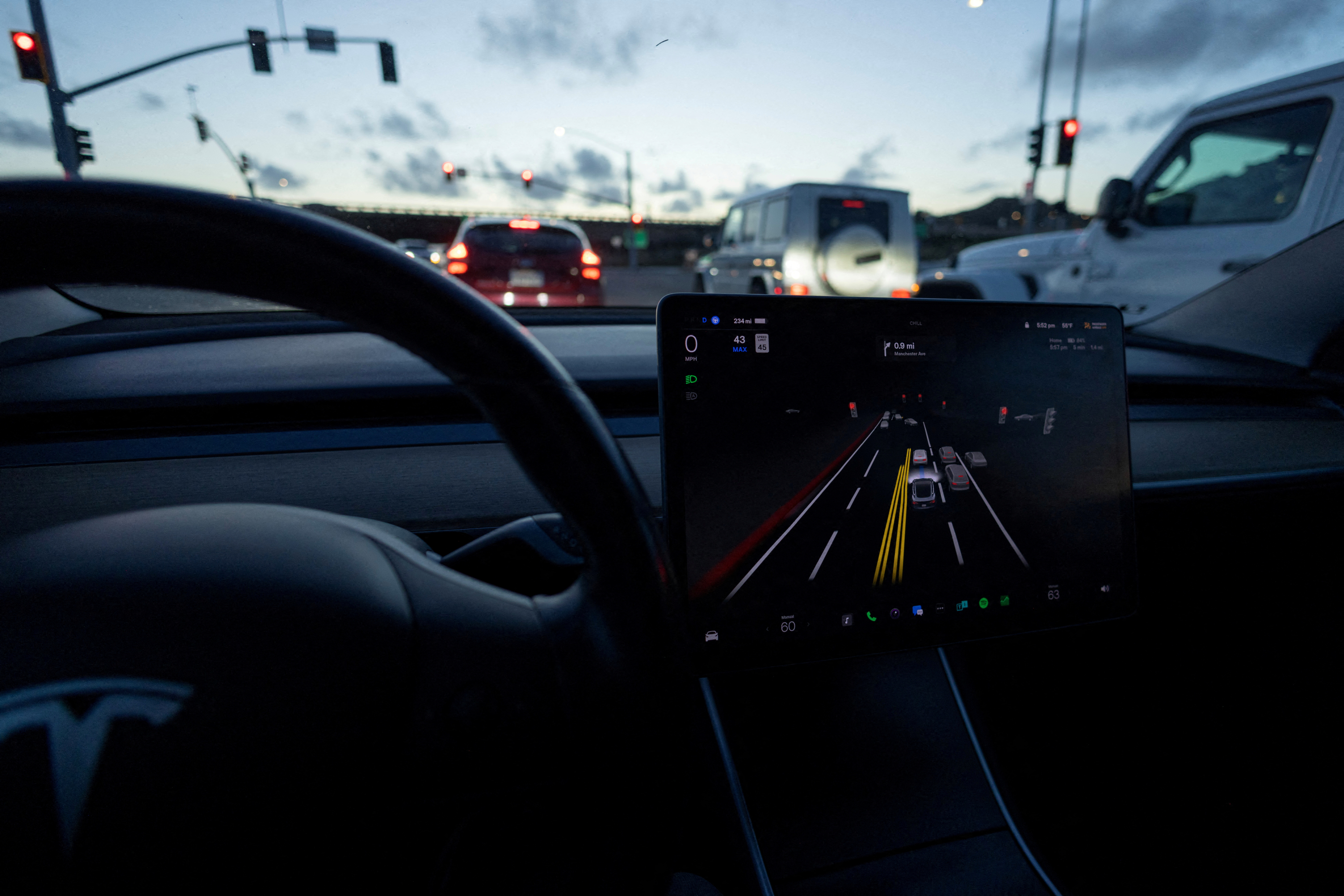 FILE PHOTO: A Tesla Model 3 vehicle is shown using the Autopilot Full Self Driving Beta software (FSD) while navigating a city road in Encinitas, California, February 2023.    REUTERS/Mike Blake