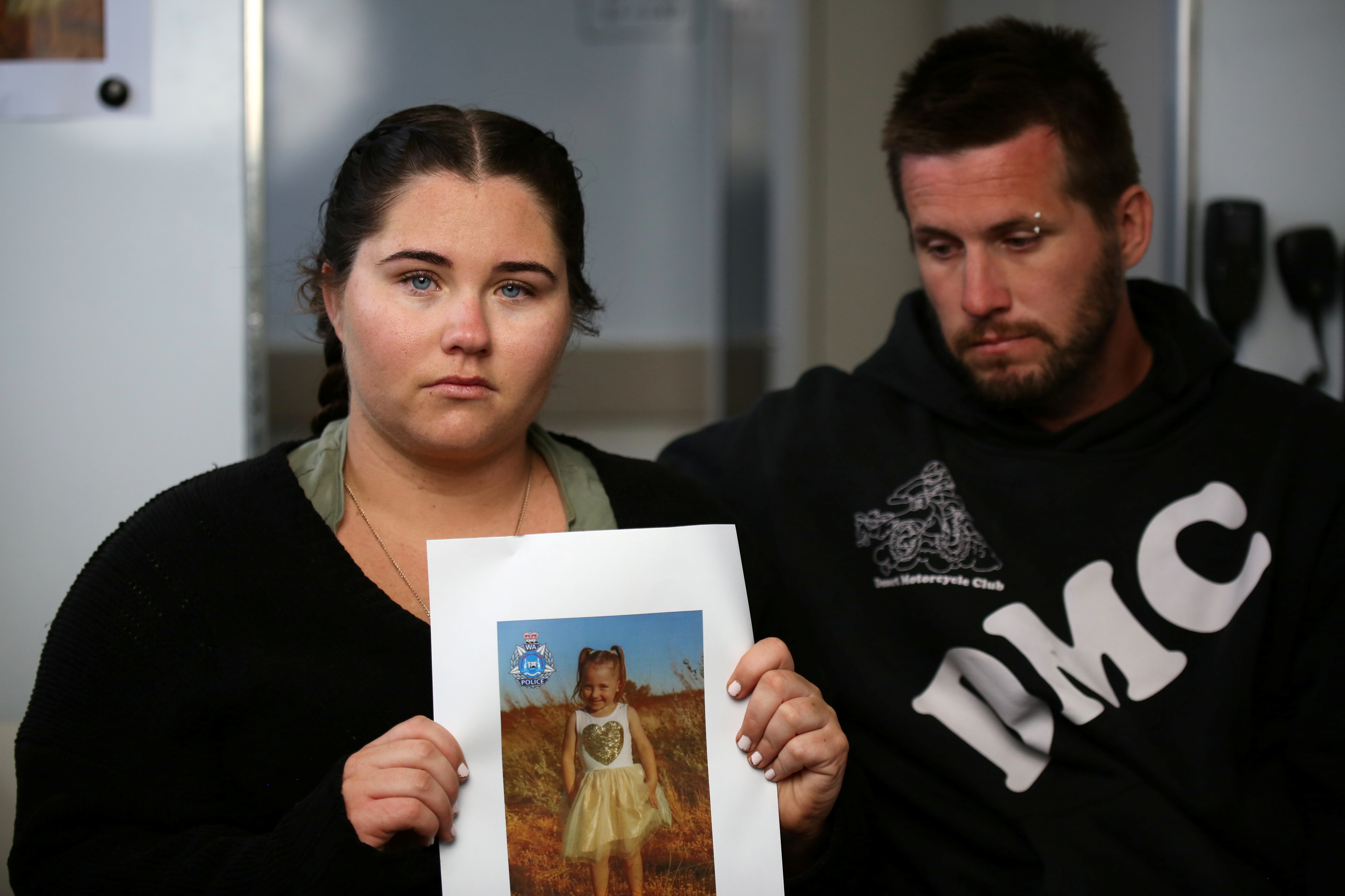 Cleo Smith’s mother Ellie Smith holds up a photo of her daughter outside Carnarvon