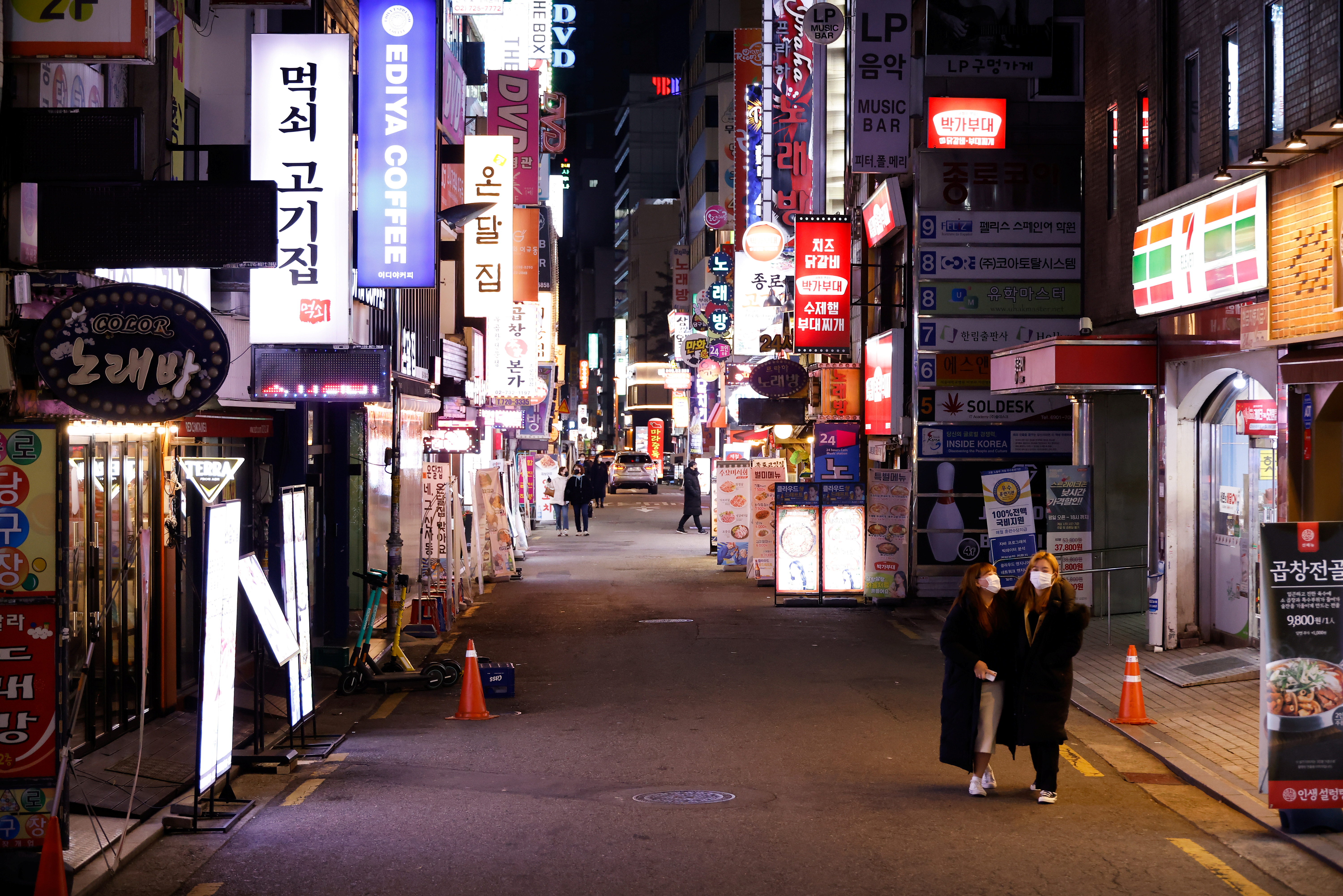 Women walk on an empty street affected by heightened social distancing rules amid the coronavirus disease (COVID-19) pandemic in Seoul