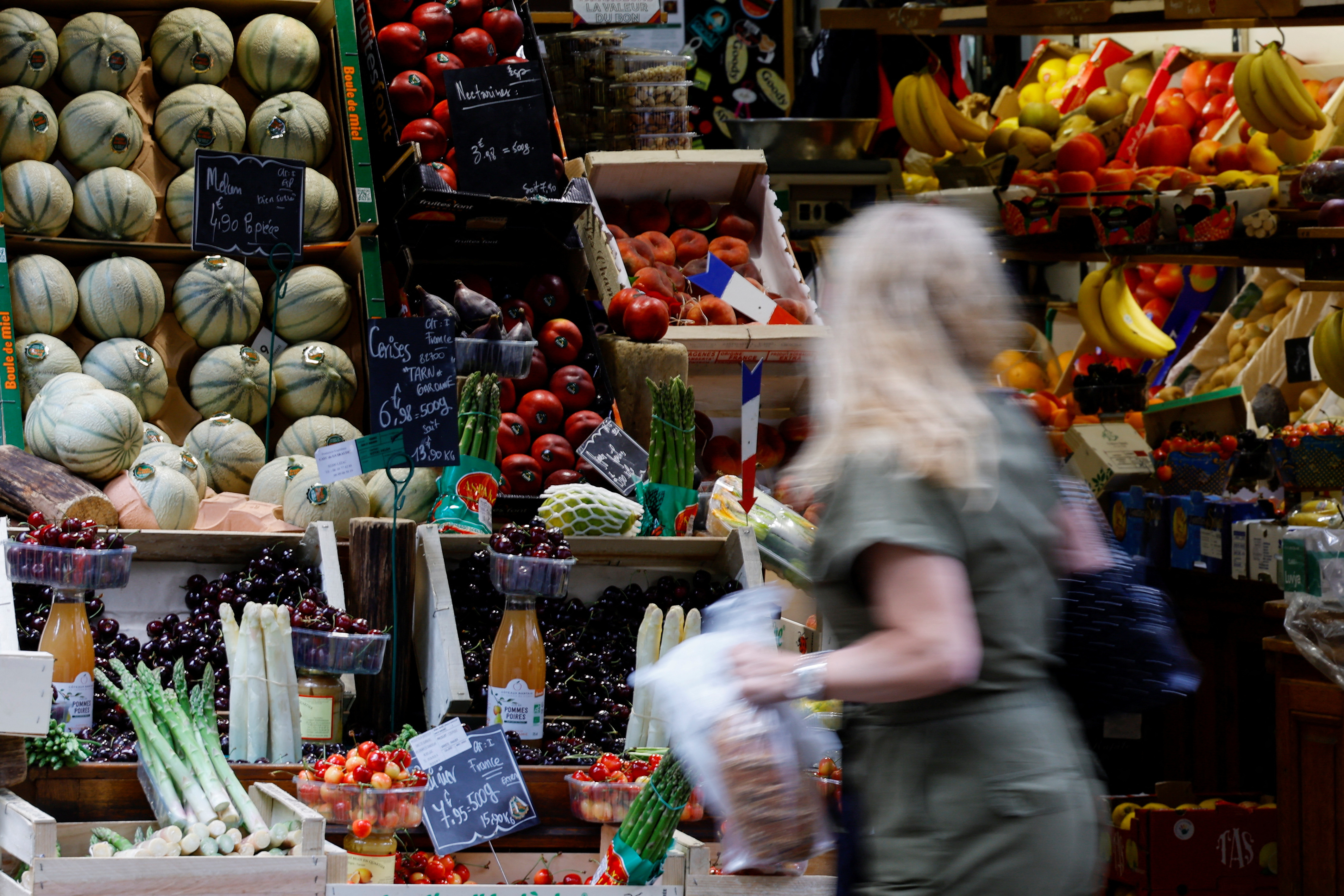 Woman shops at fruit and vegetables shop in Paris