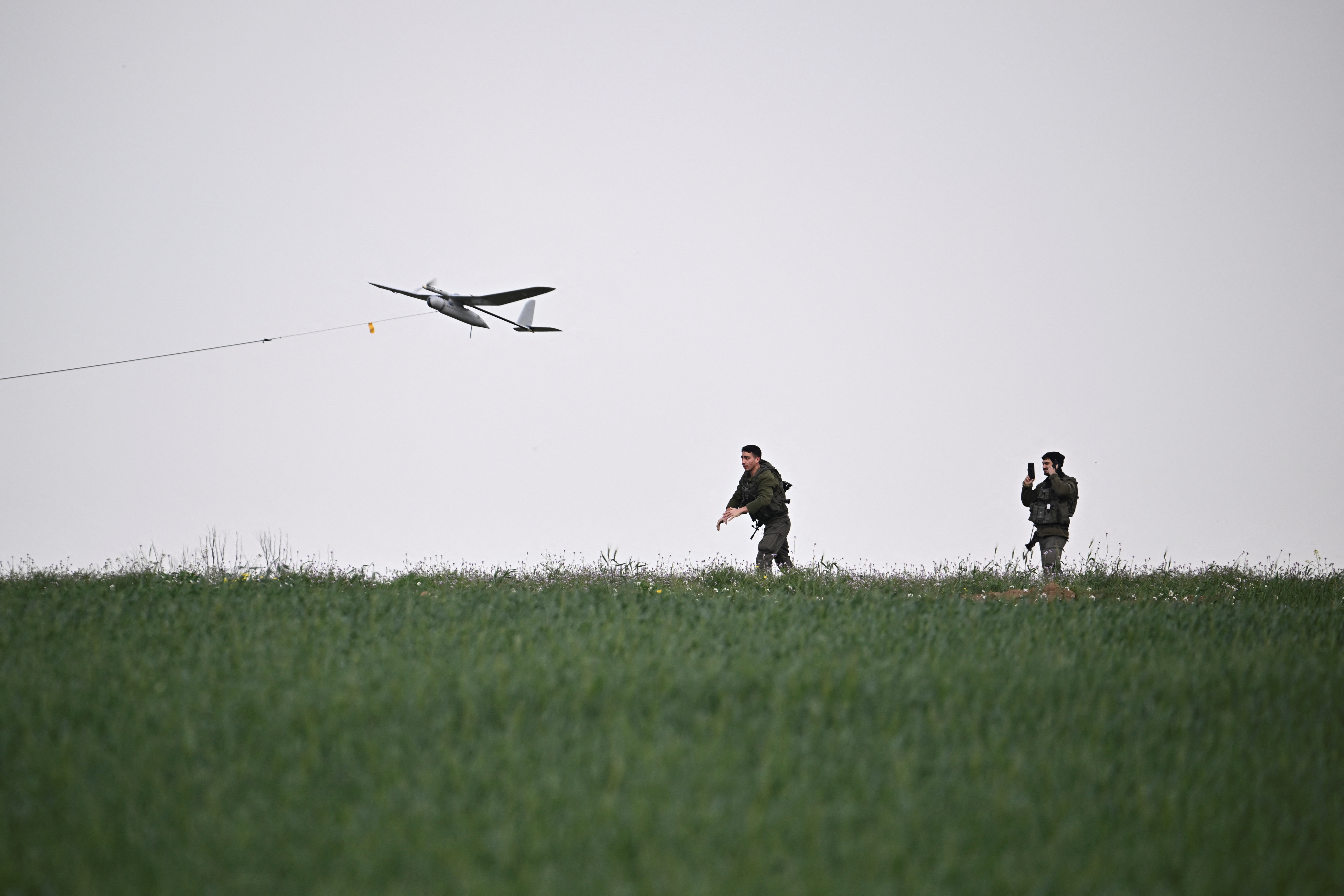 An Israeli soldier launches a drone near the Israel-Gaza border