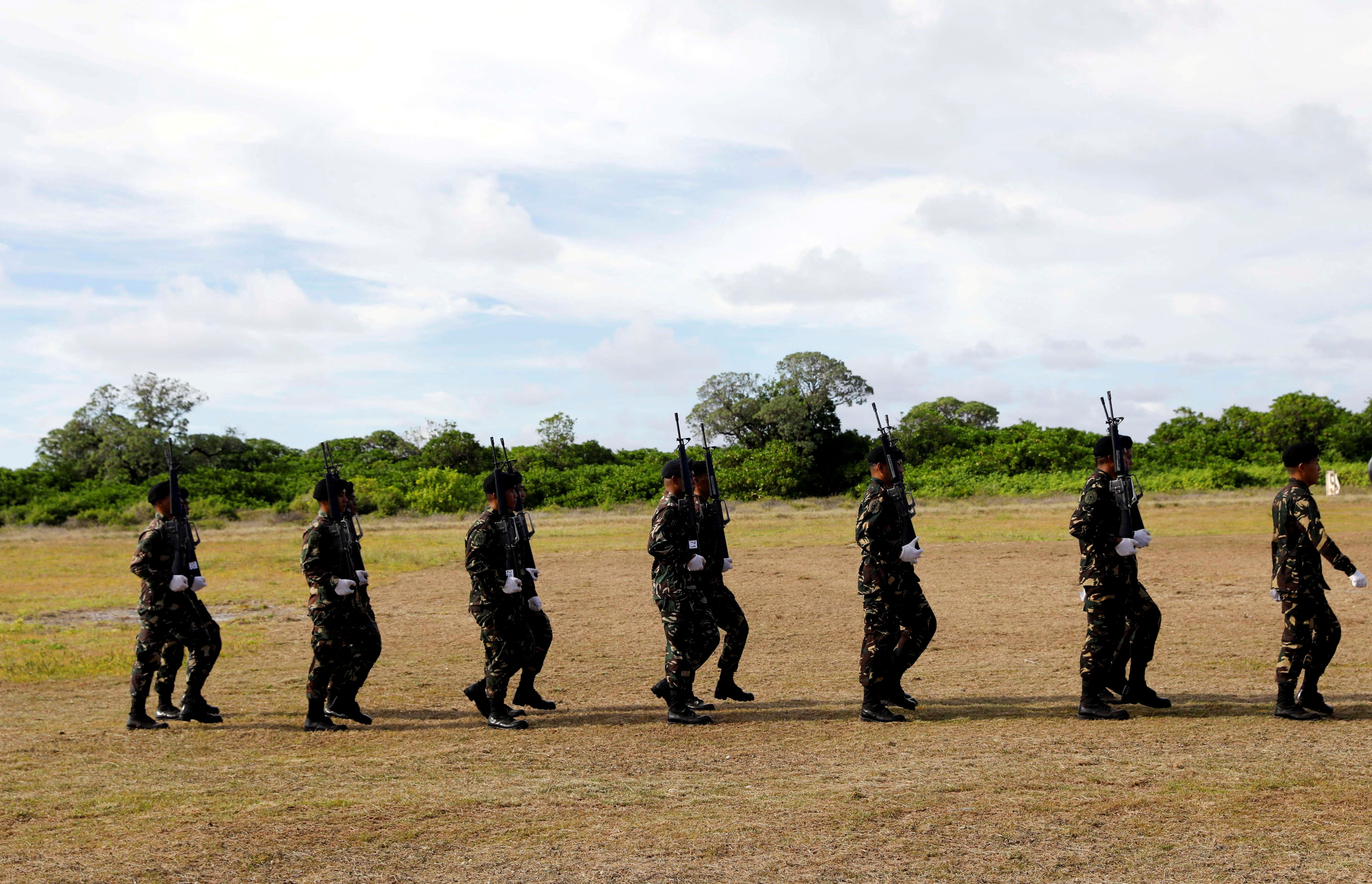 Filipino soldiers march in Thitu island