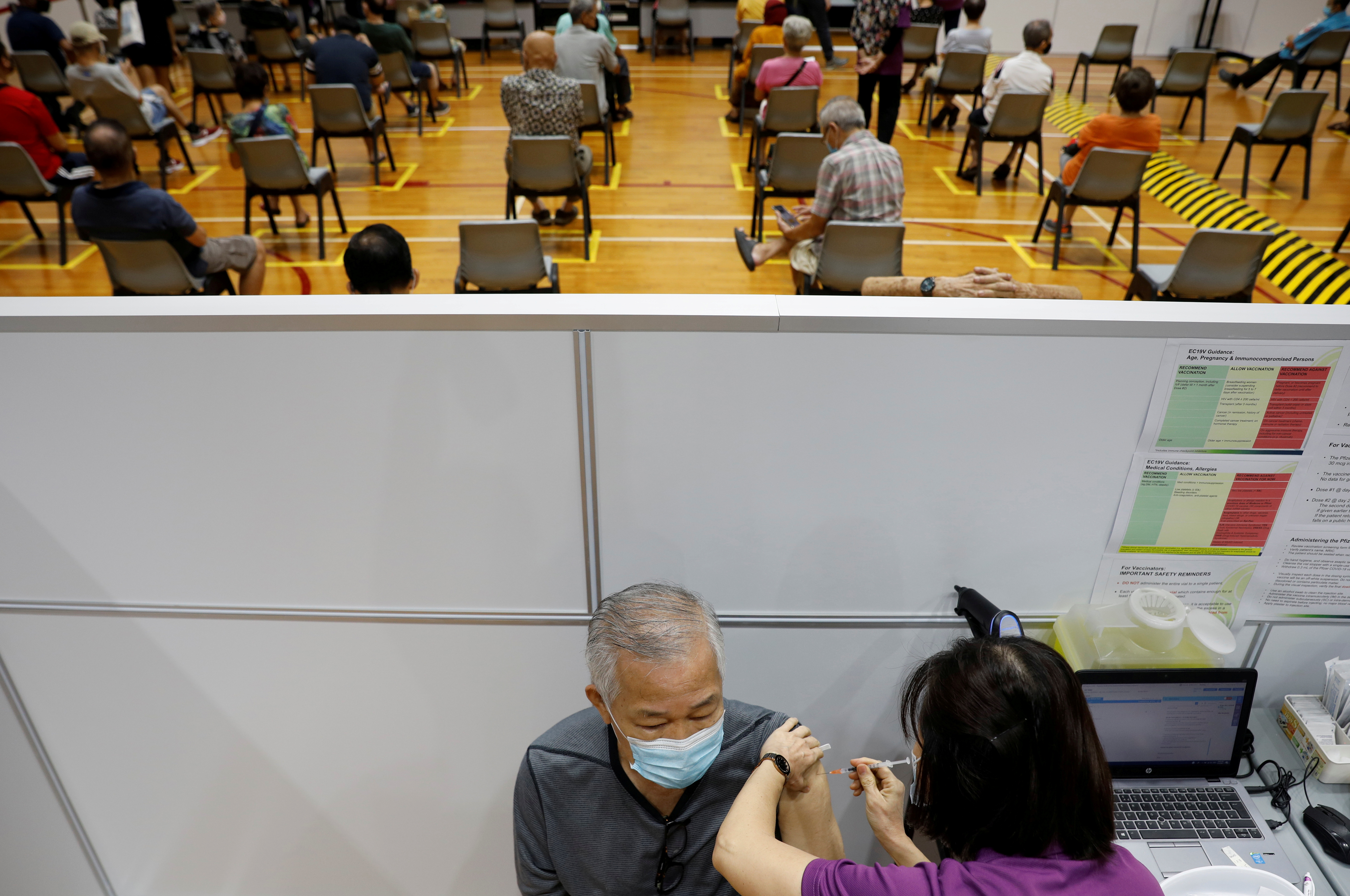 A man receives his vaccination at a coronavirus disease (COVID-19) vaccination center in Singapore