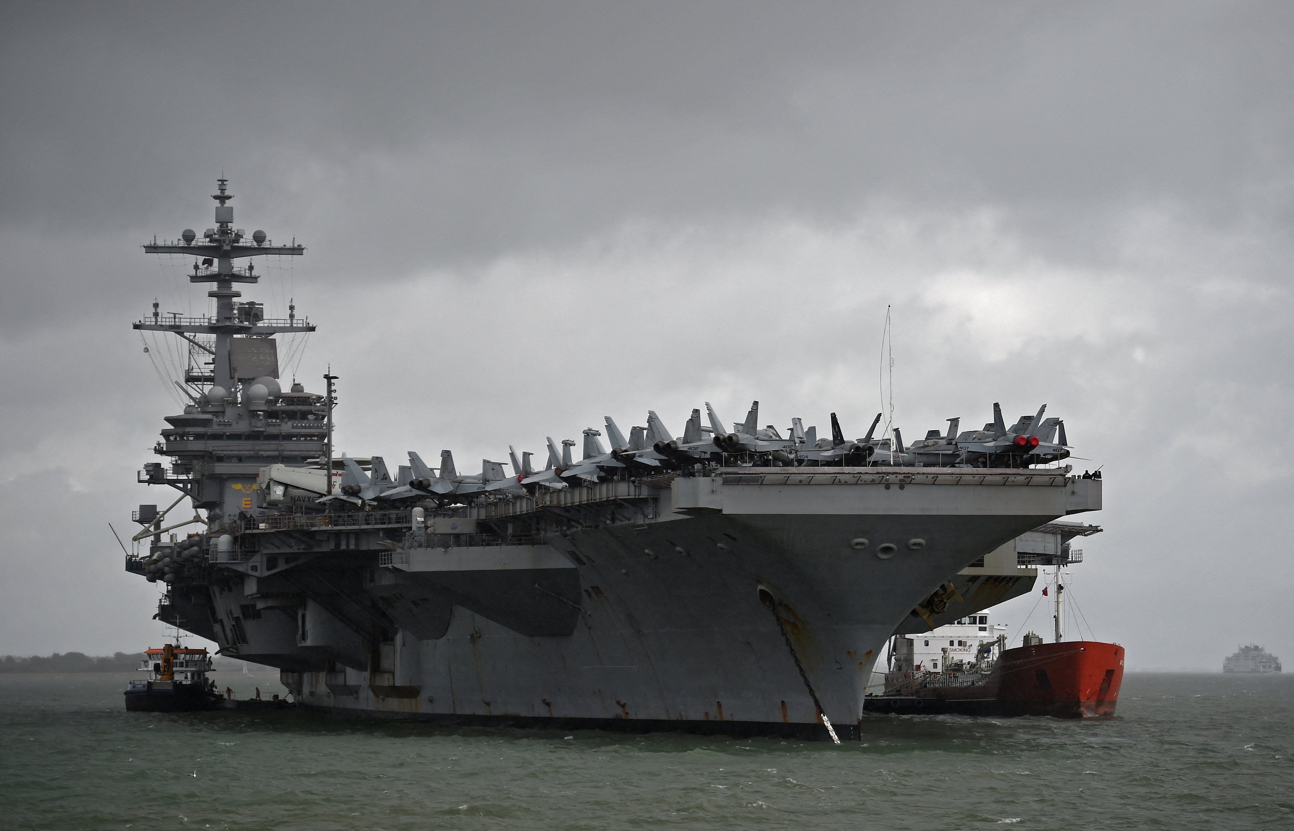 The USS George H.W. Bush aircraft carrier is seen anchored off Stokes Bay in the Solent