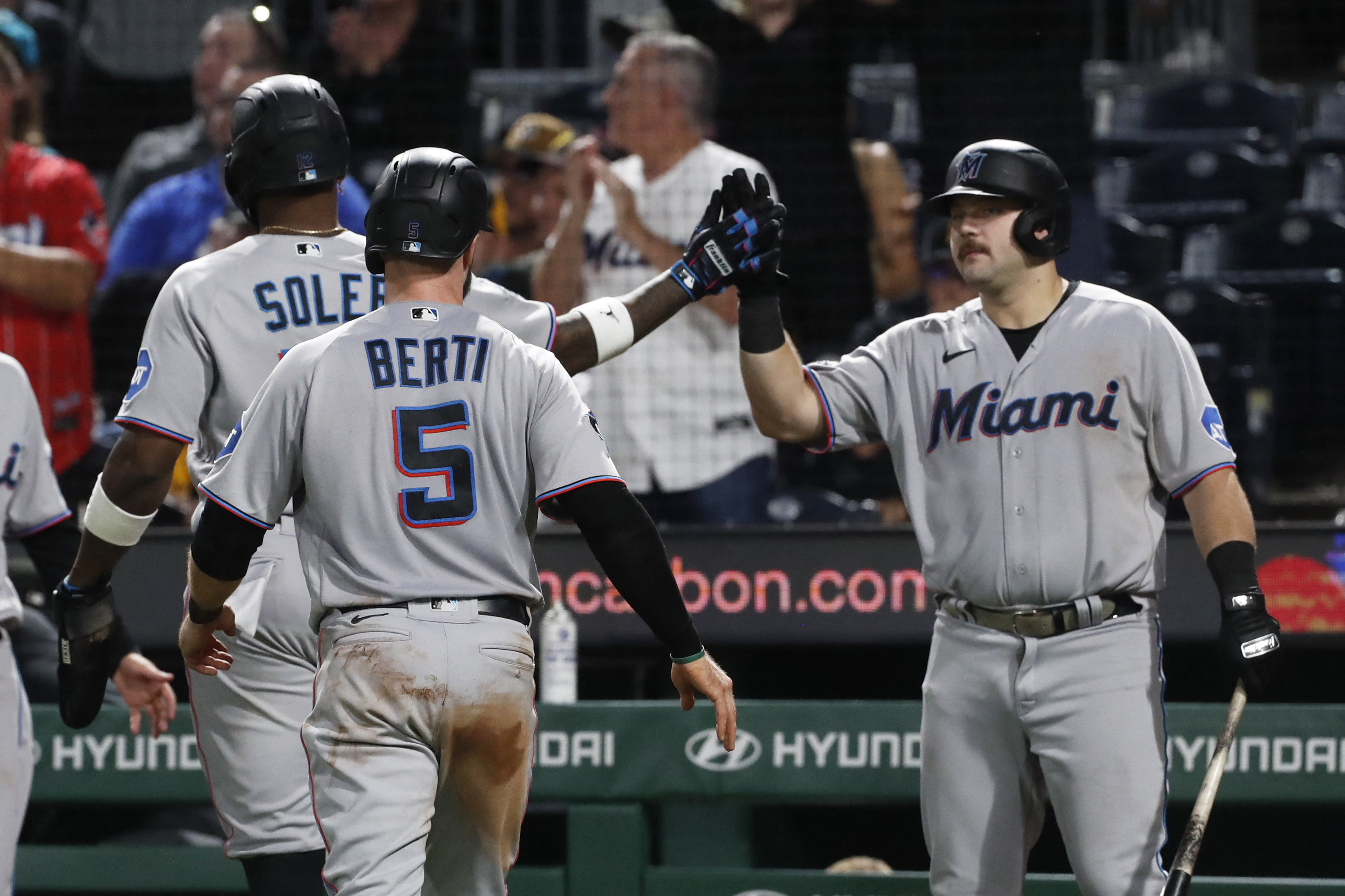 A.J. Puk of the Miami Marlins celebrates with Brant Brown hitting