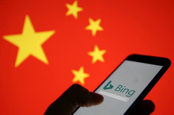 A smartphone with the Microsoft Bing logo is displayed against the backdrop of a Chinese flag in this picture illustration
