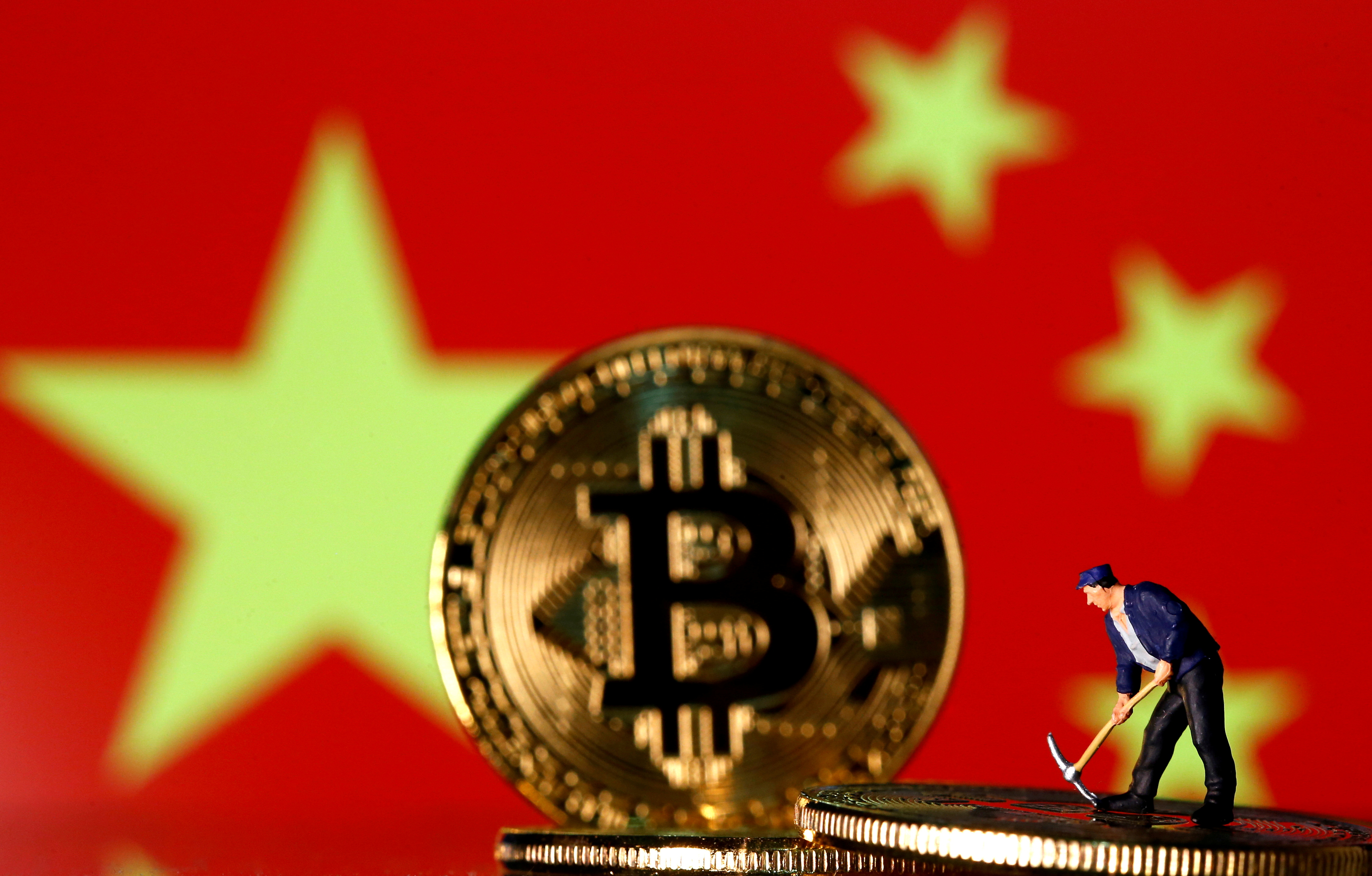 Picture illustration of a small toy figurine and representations of the Bitcoin virtual currency displayed in front of an image of China's flag