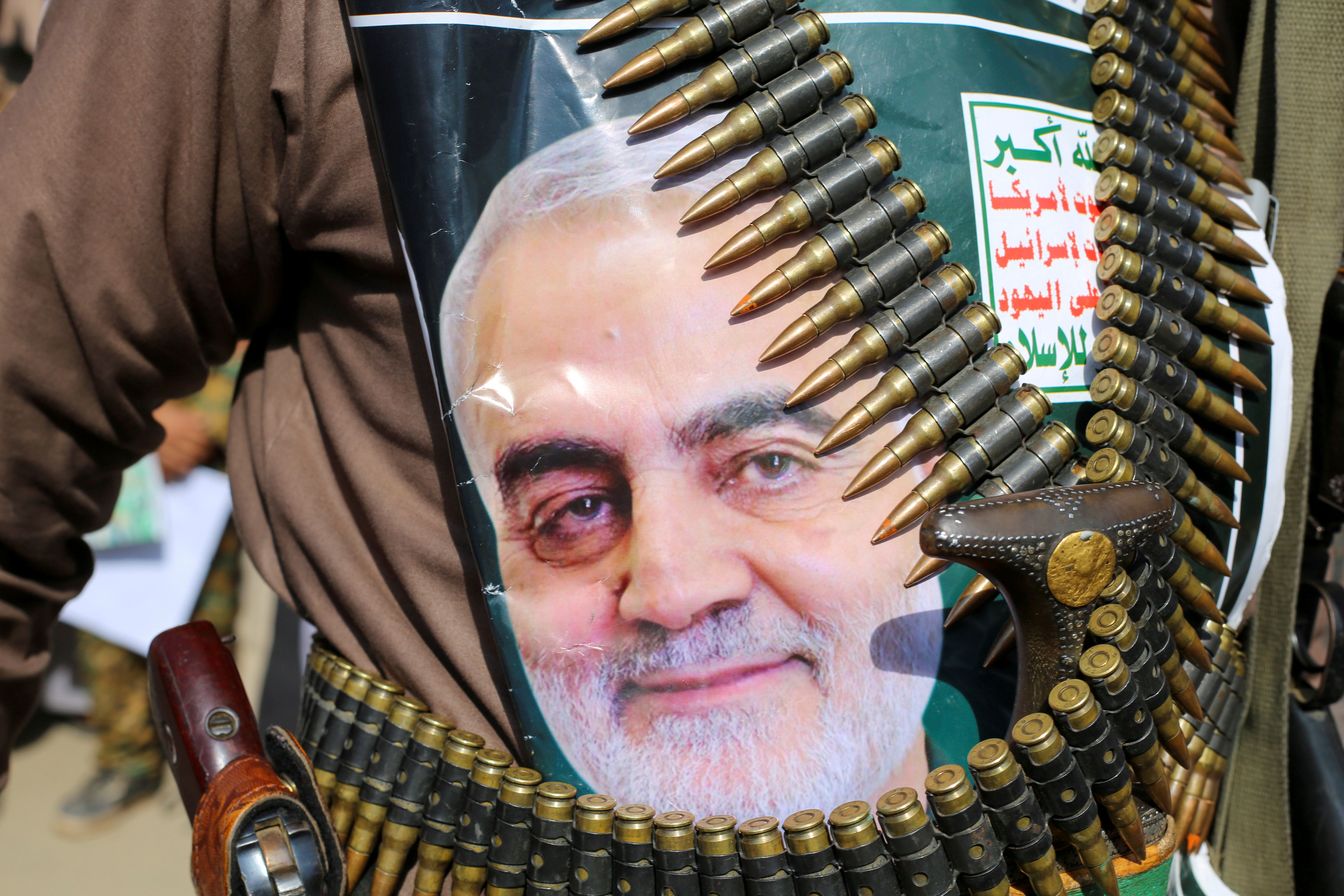 A supporter of the Houthis has a poster attached to his waist of Iranian Major-General Qassem Soleimani, head of the elite Quds Force, who was killed in an air strike at Baghdad airport, during a rally to denounce the U.S. killing, in Saada