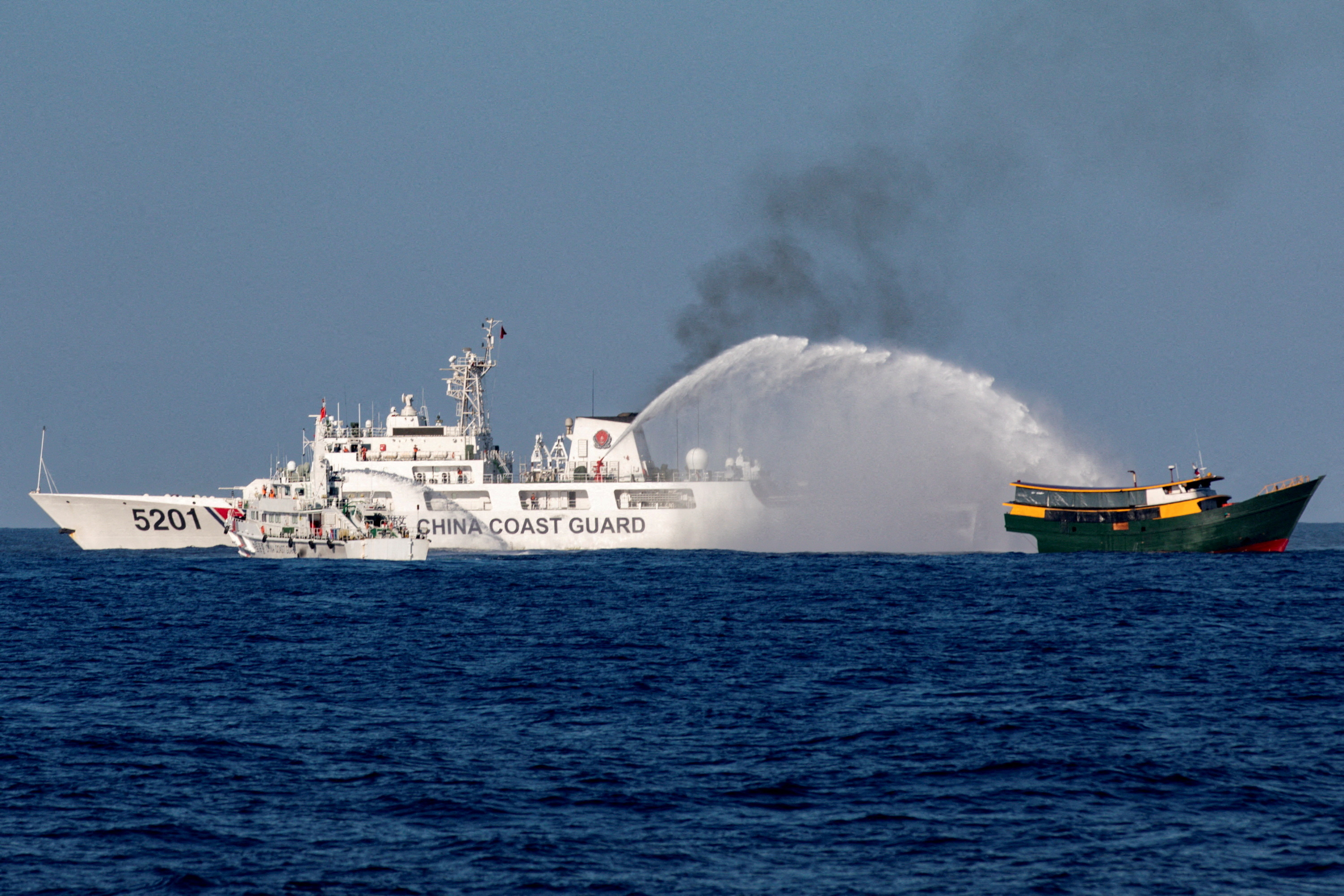 Chinese Coast Guard vessels fire water cannons towards a Philippine resupply vessel Unaizah May 4 on its way to a resupply mission at Second Thomas Shoal in the South China Sea