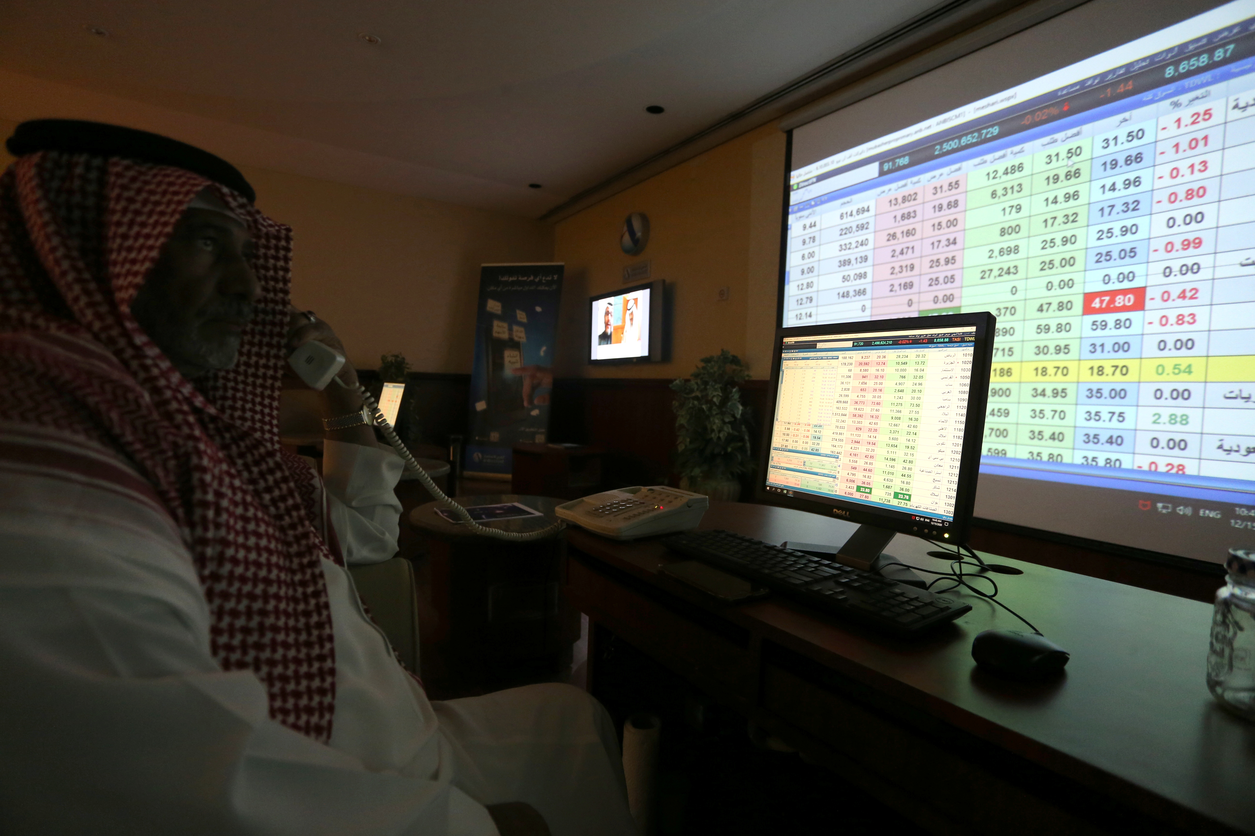 A Saudi trader monitors stock information at ANB Bank in Riyadh, Saudi Arabia December 15, 2020. REUTERS/Ahmed Yosri
