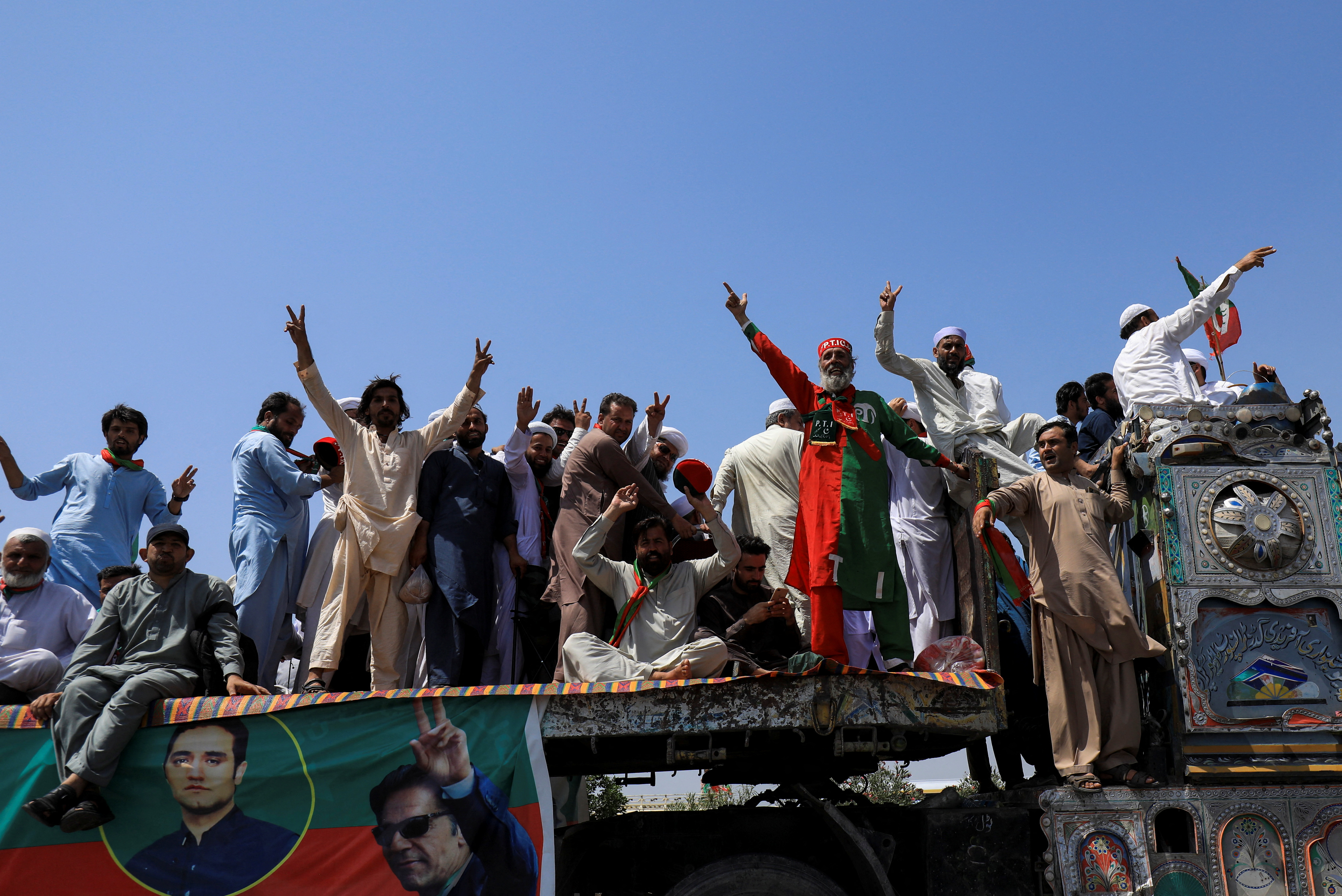 People attend a protest march led by ousted Pakistani PM Khan, in Sawabi