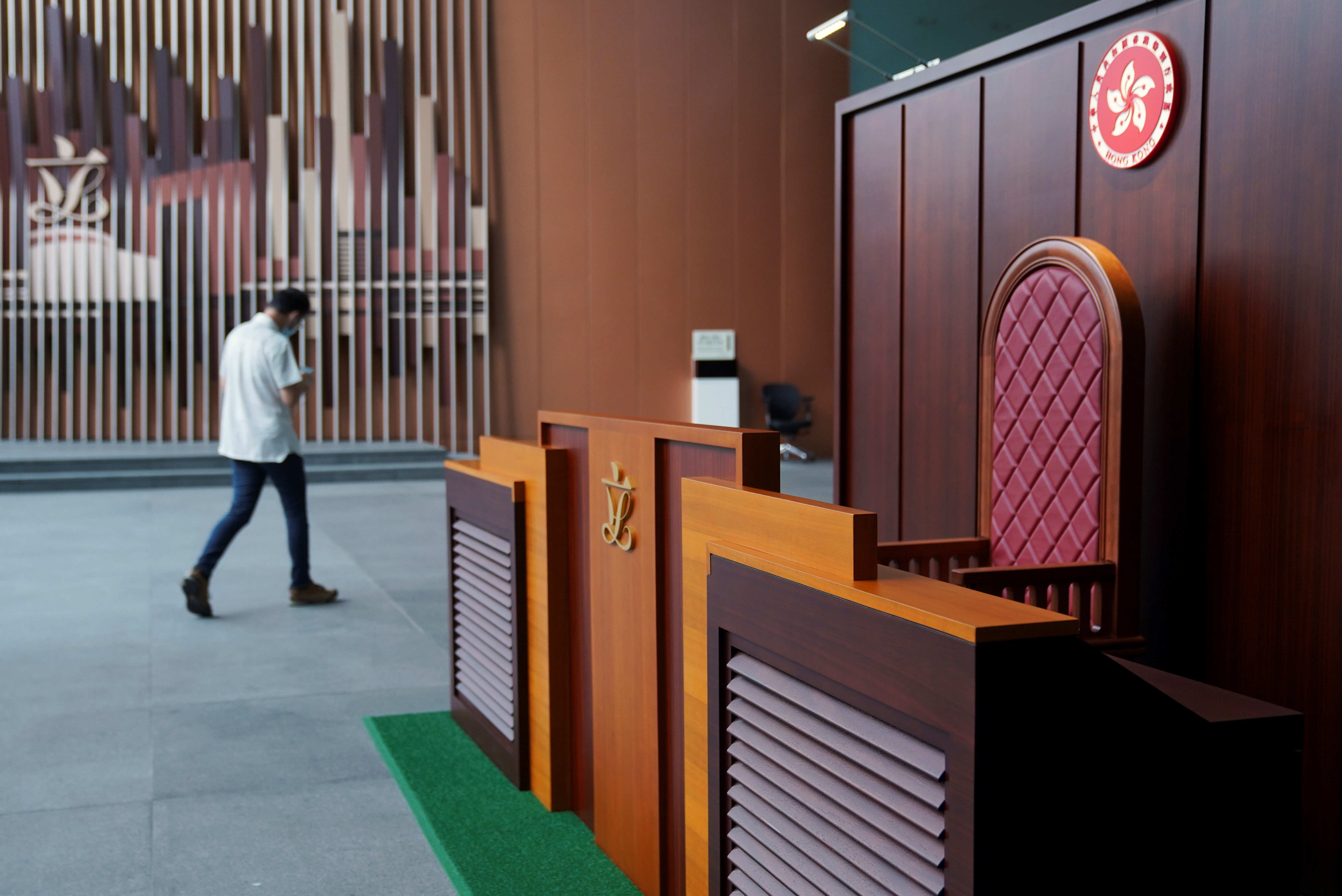 Man walks past a model of the president's seat at the Legislative Council in Hong Kong