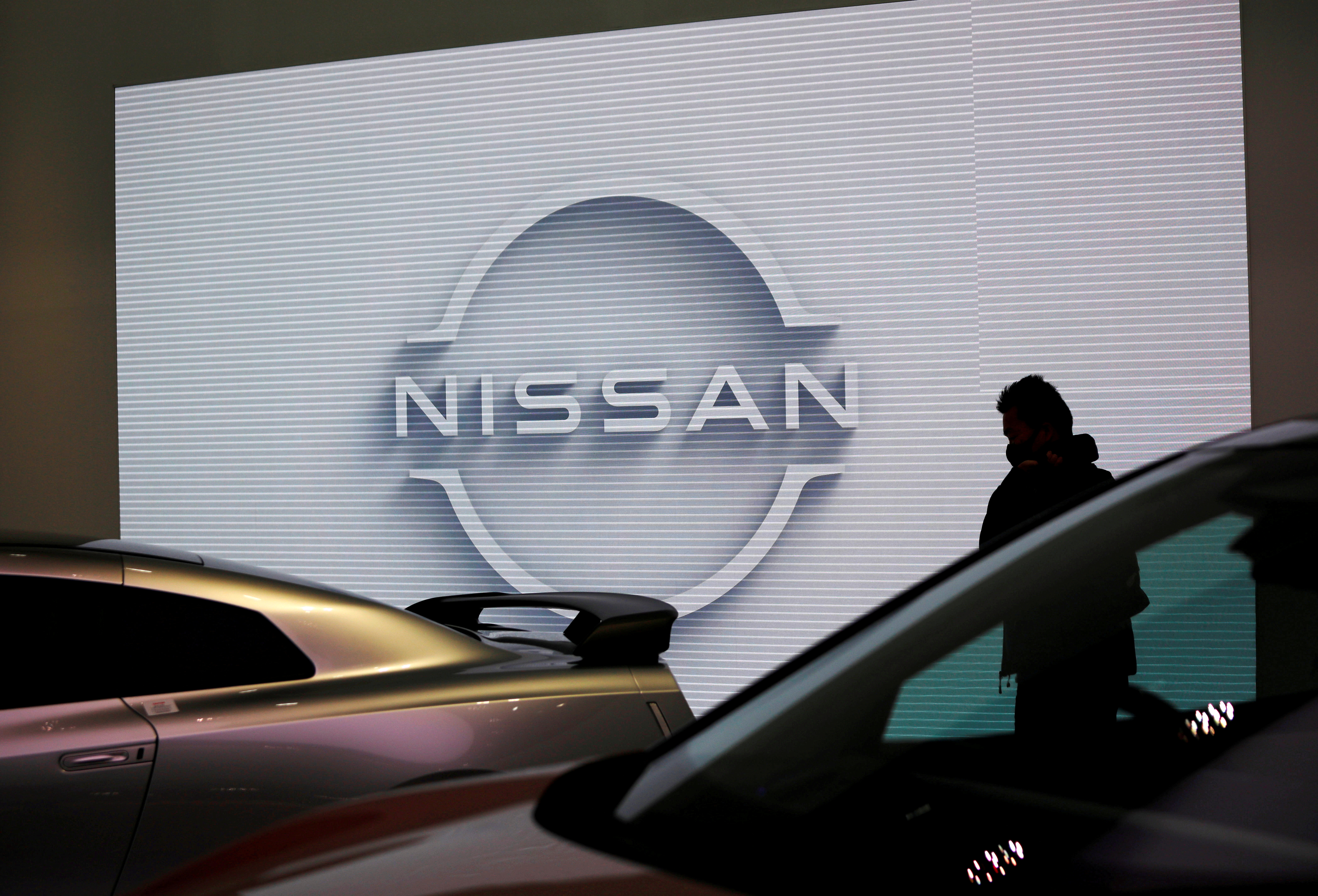 A visitor is seen at a Nissan Motor Corp. showroom in Tokyo, Japan