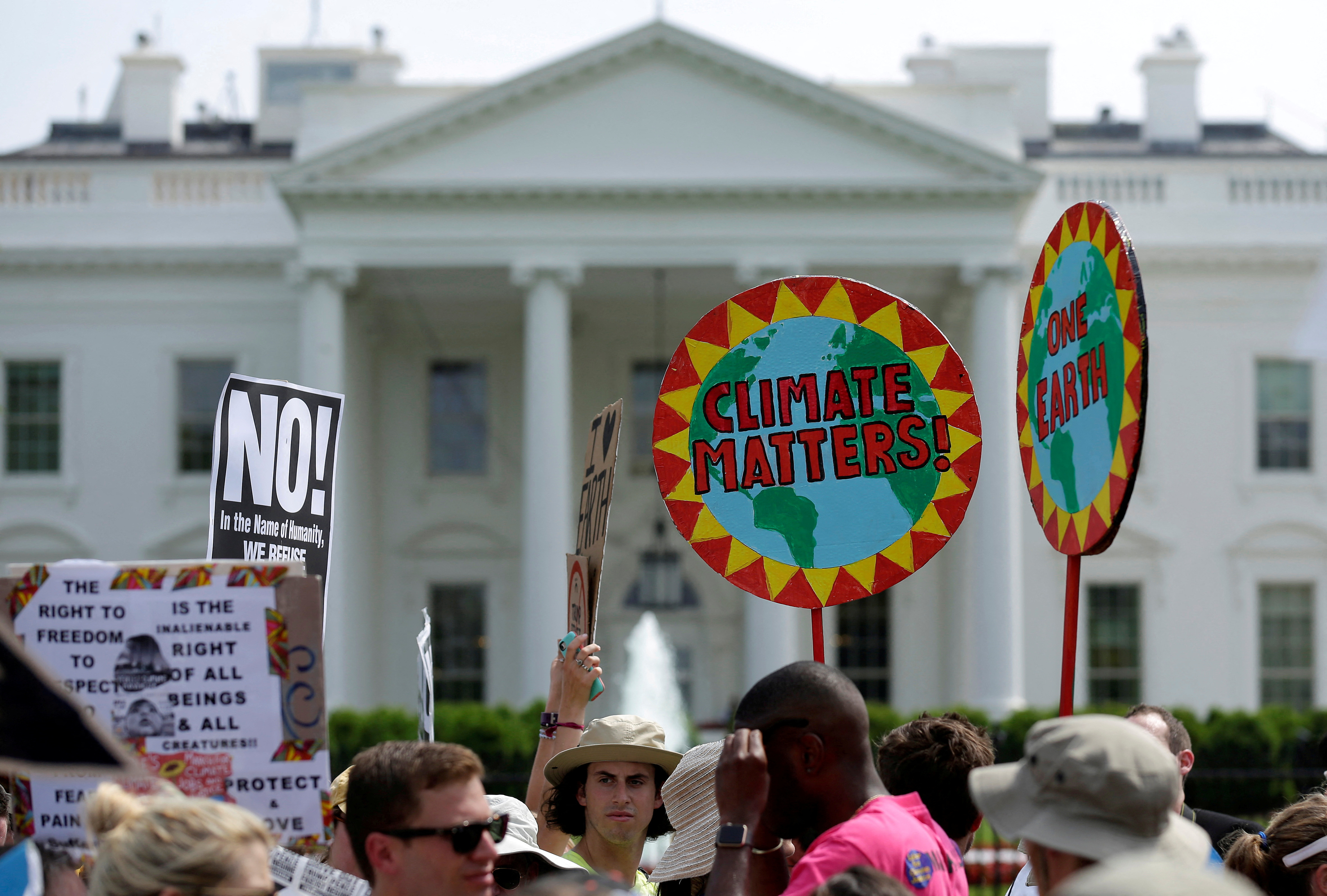 Protesters carry signs during the Peoples Climate March at the White House in Washington