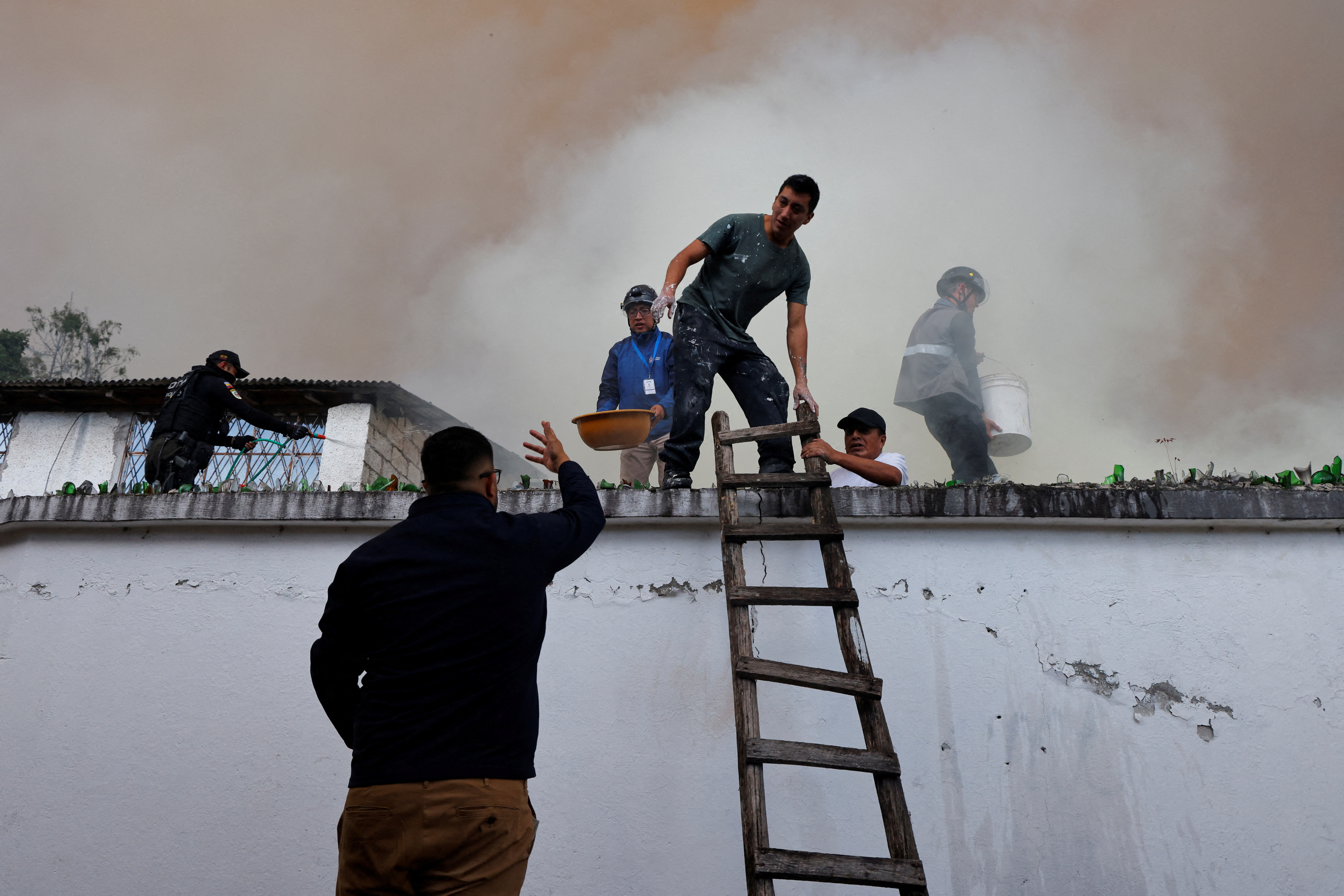 Firefighters work to extinguish a wildfire, in Quito