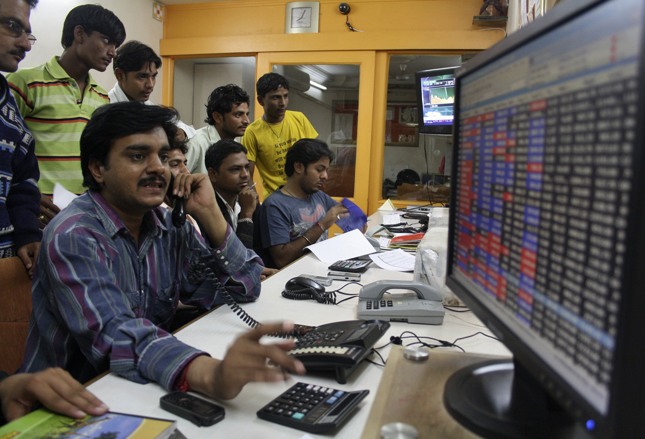 A trader works at a stock brokerage in the western Indian city of Ahmedabad