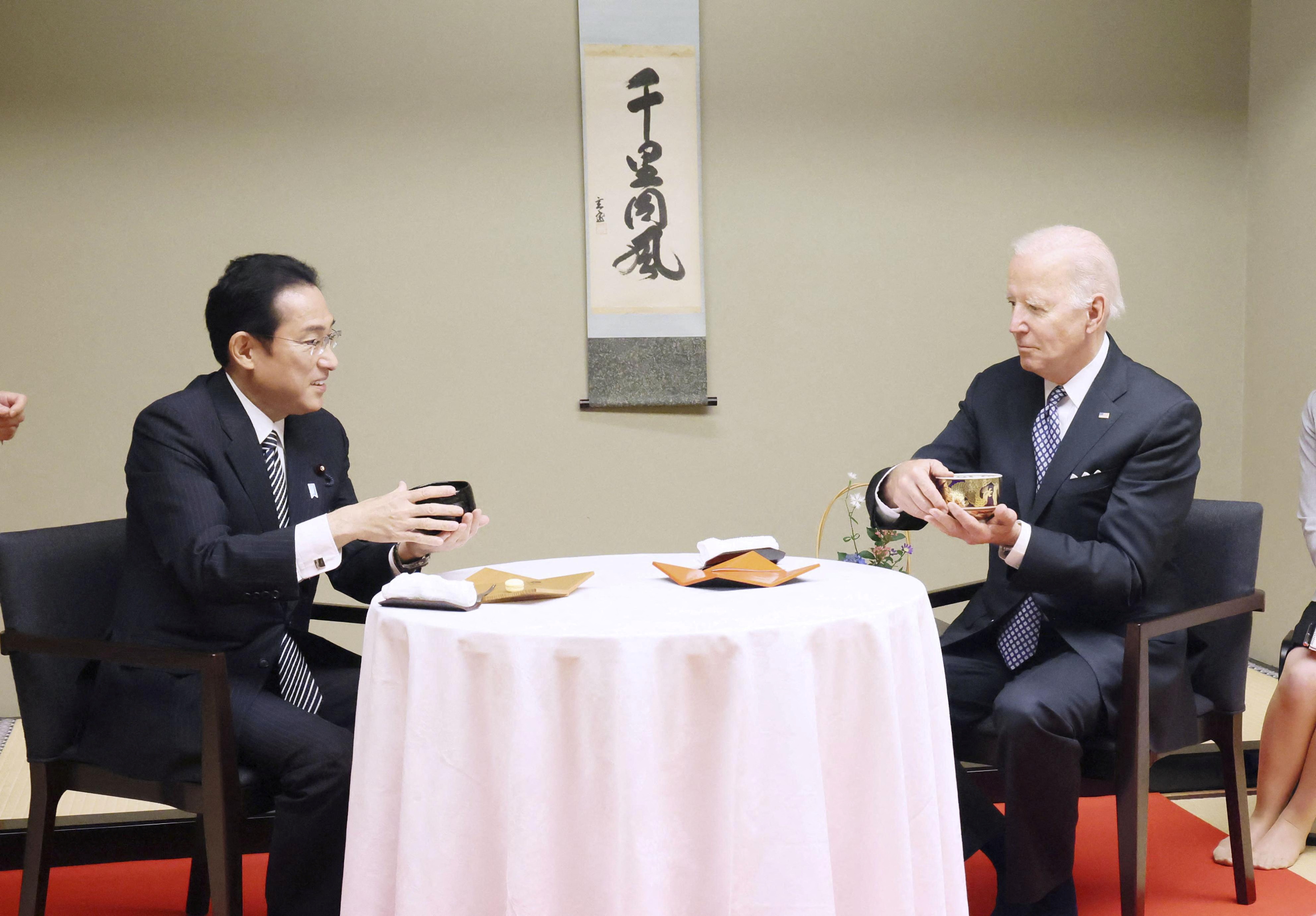 U.S. President Joe Biden experiences a traditional tea ceremony with Japan's Prime Minister Fumio Kishida during a private dinner in Tokyo