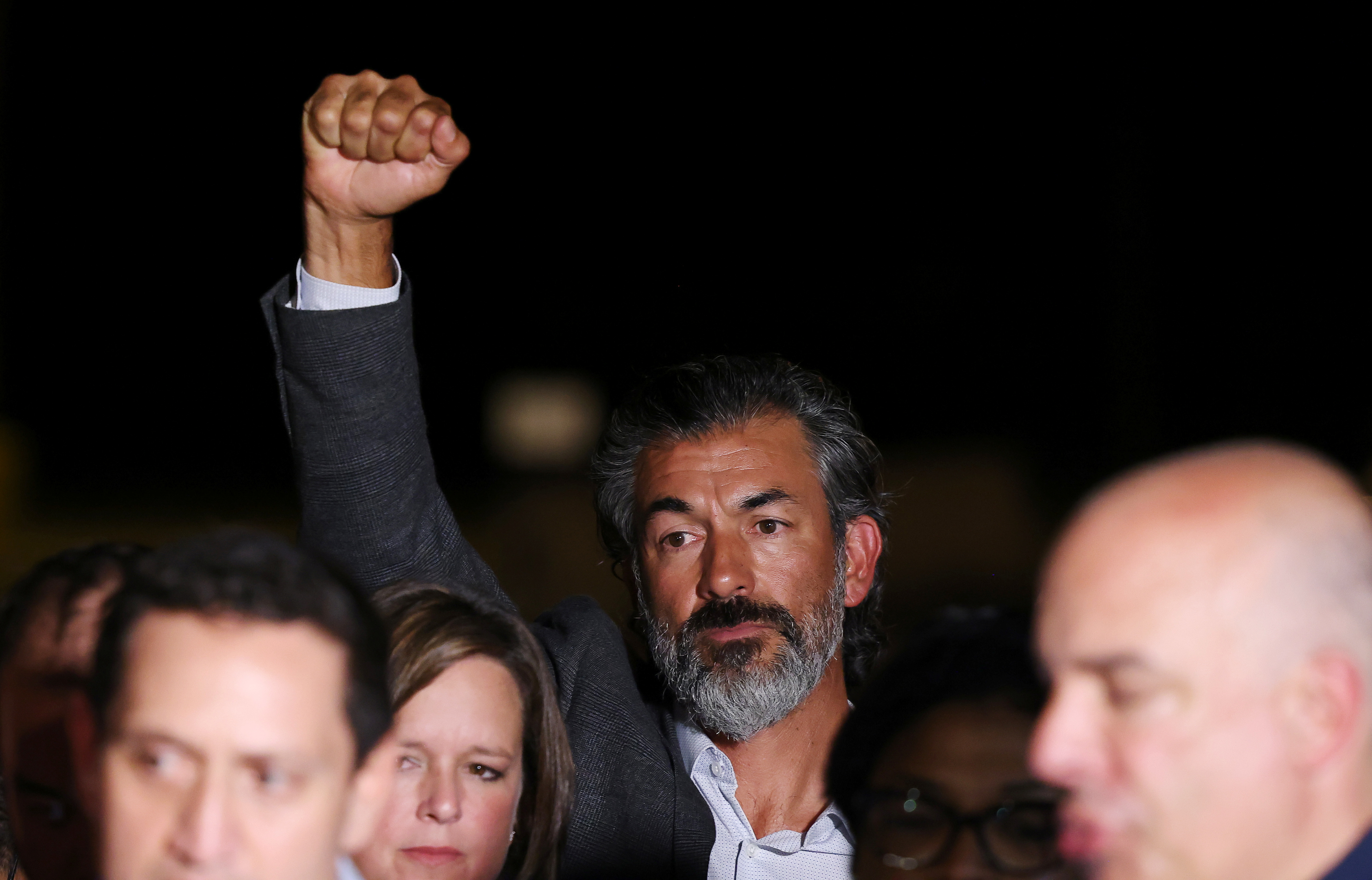 Representative Ramon Romero raises his fist as Democratic members of the Texas House of Representatives, who are boycotting a special session of the legislature in an effort to block Republican-backed voting restrictions, arrive at Dulles airport in Sterling, Virginia, U.S., July 12, 2021. REUTERS/Evelyn Hockstein