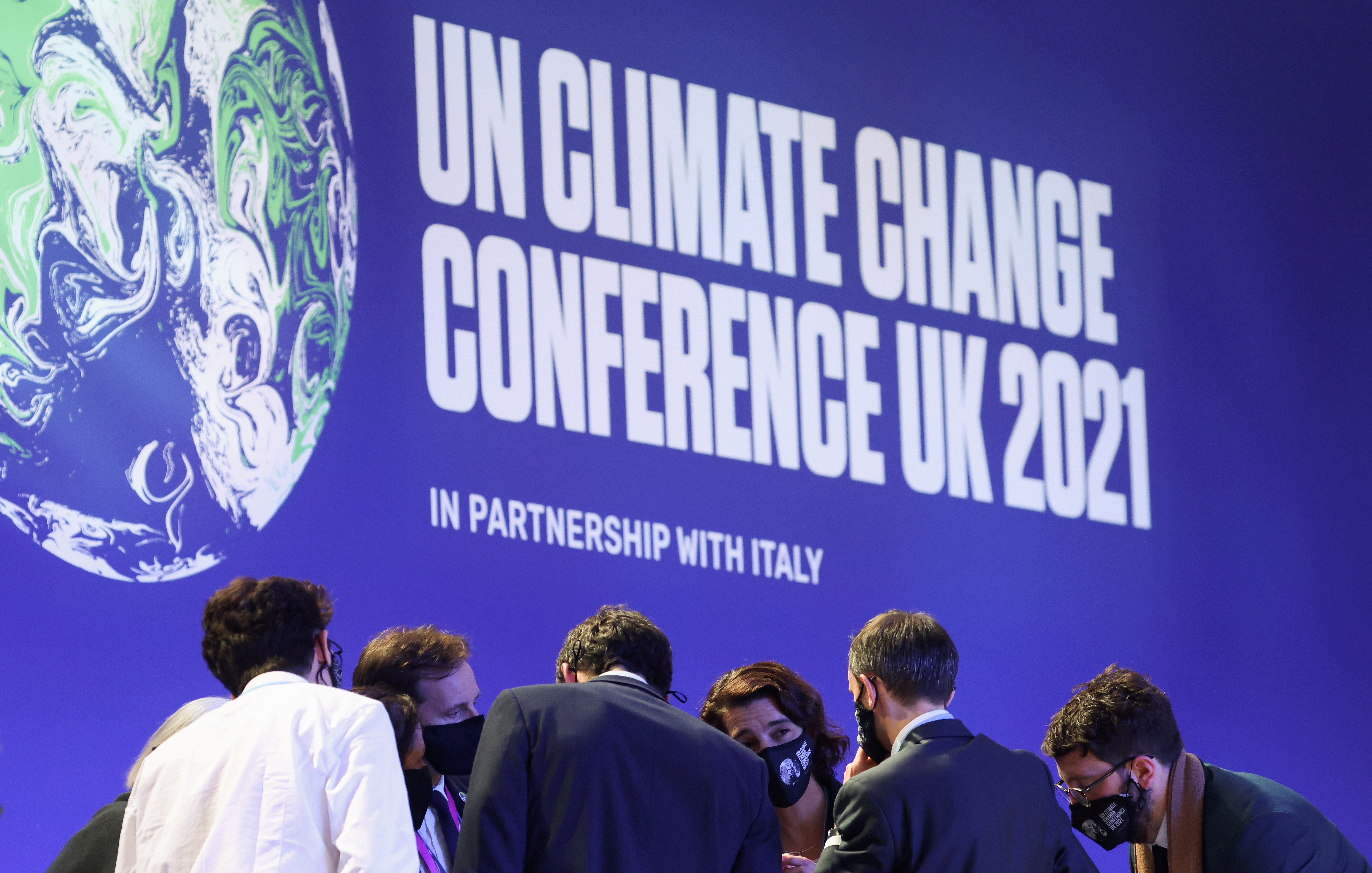 Delegates talk during the UN Climate Change Conference (COP26) in Glasgow, Scotland, Britain November 13, 2021. REUTERS/Yves Herman