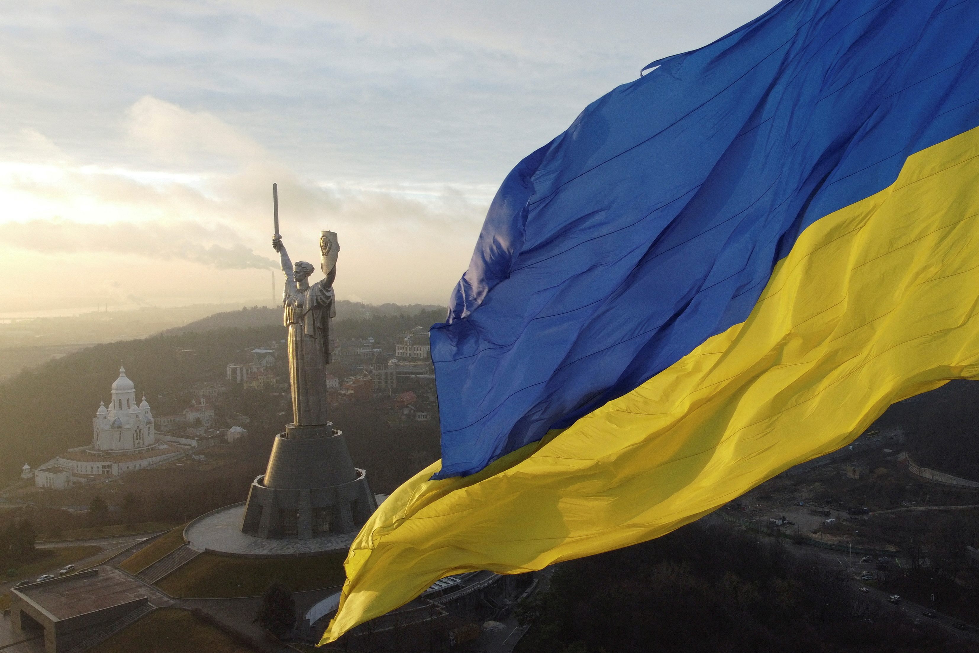 Ukraine's biggest national flag on the country's highest flagpole and the giant 'Motherland' monument are seen at a compound of the World War II museum in Kyiv, Ukraine, December 16, 2021. Picture taken with a drone. REUTERS/Valentyn Ogirenko