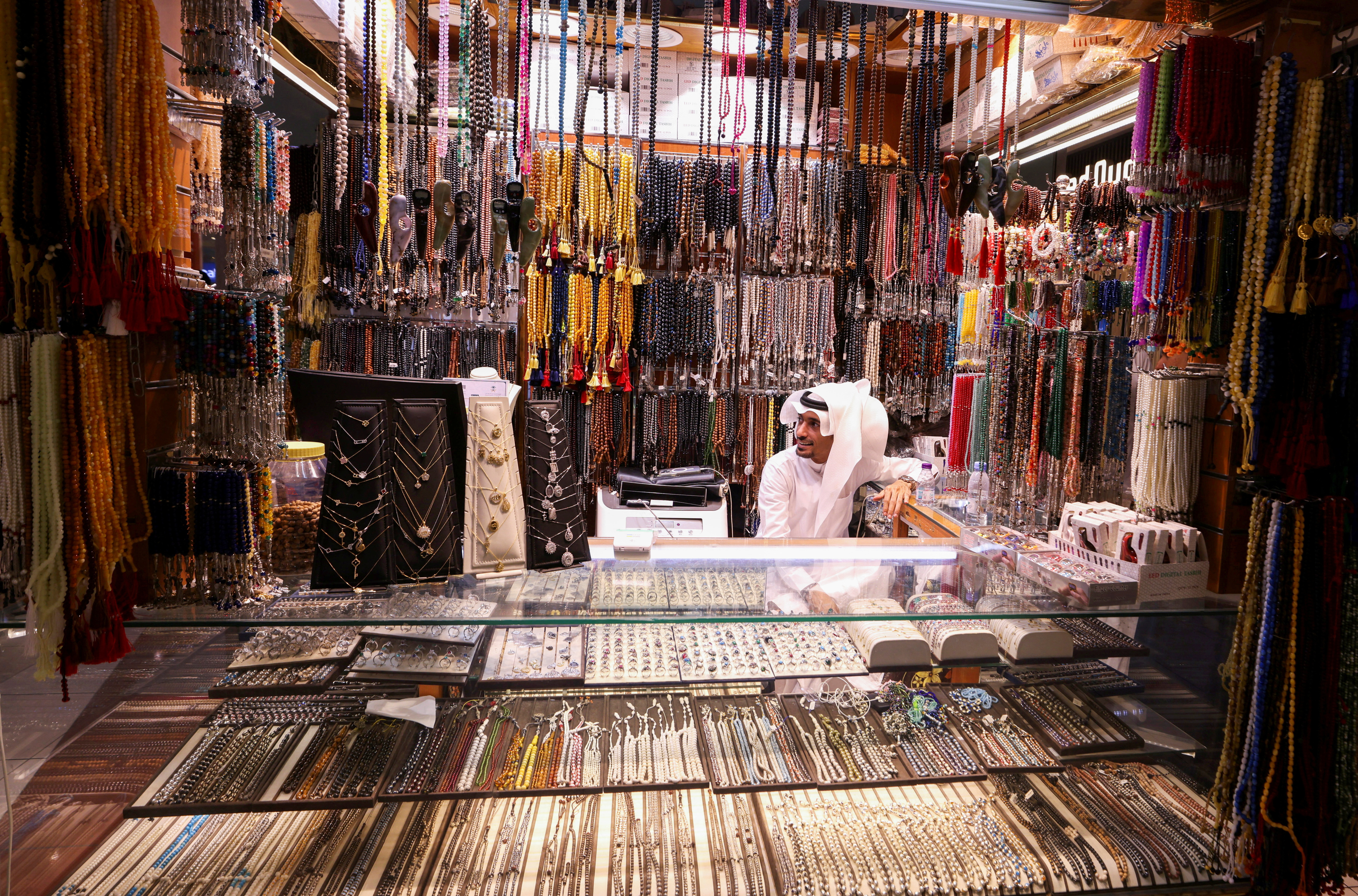 A seller waits for pilgrims in his shop at El-Sa'a mall, as Muslims start arriving to perform the annual haj in the Grand Mosque, in the holy city of Mecca