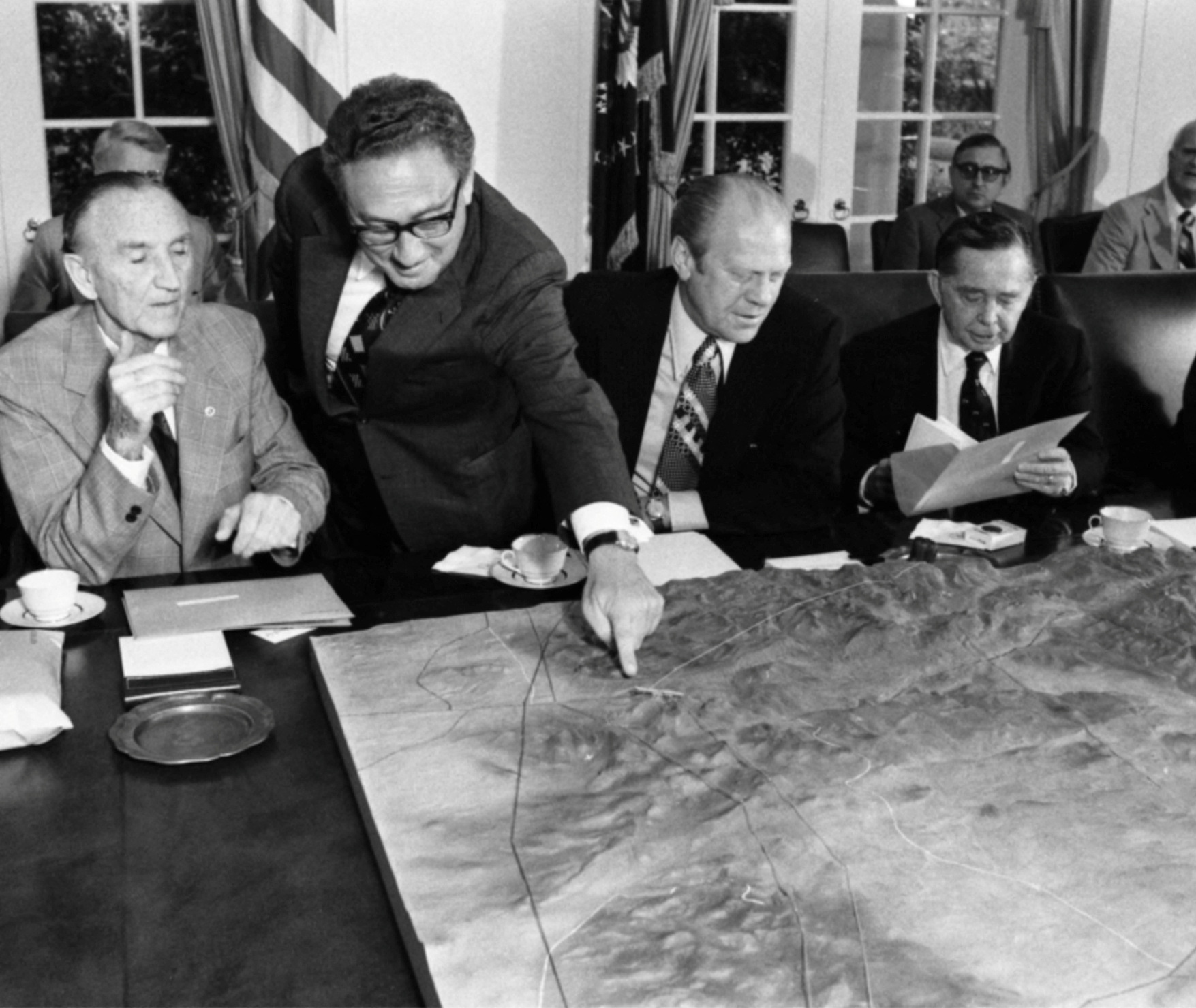 Henry Kissinger points to a map of the Sinai during a meeting with U.S. President Gerald Ford and congressional members in the Cabinet Room at the White House in Washington DC, U.S., January 20, 1977.  via Gerald R. Ford Library 