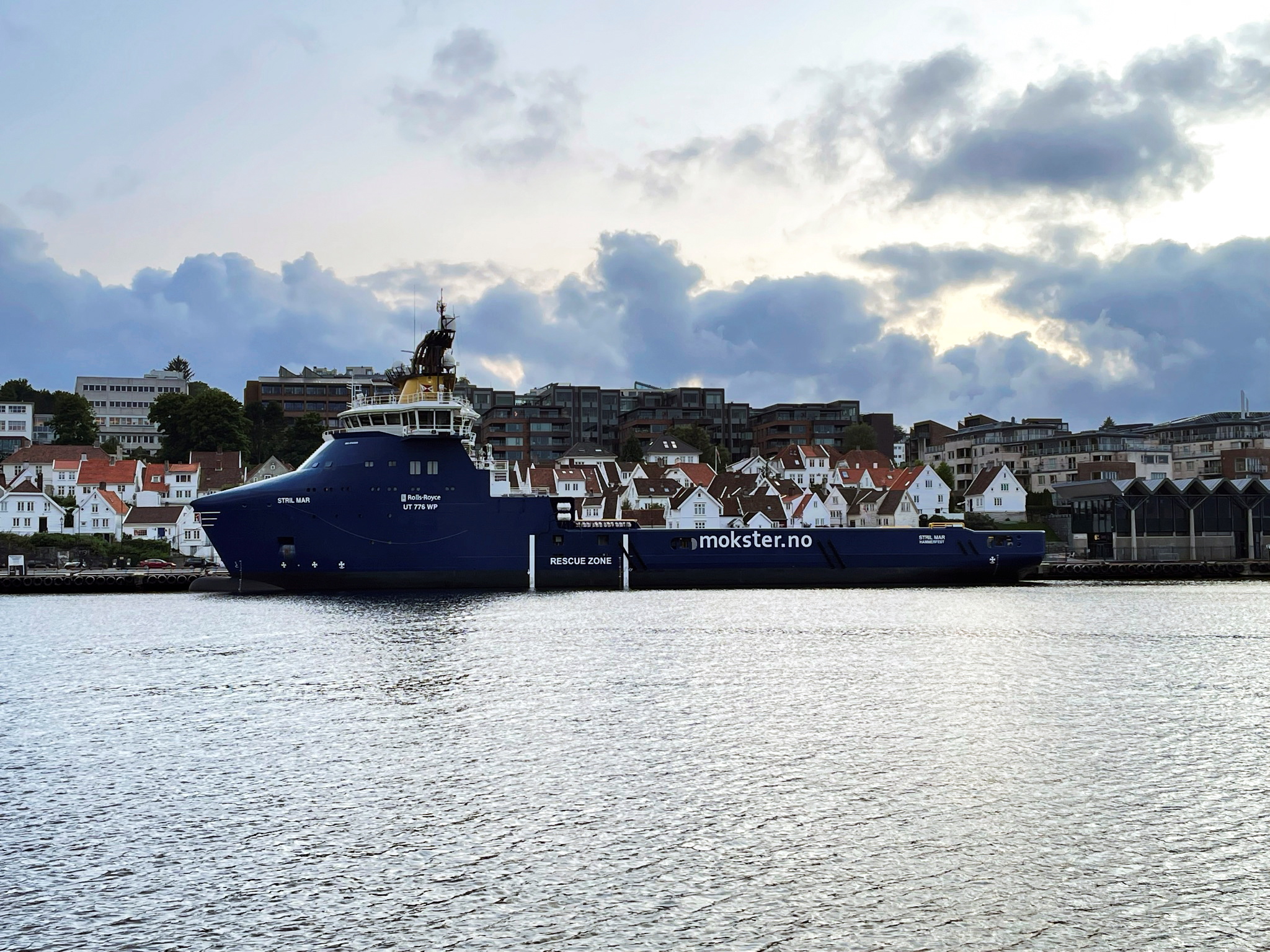 Offshore oil and gas platform supply vessel is docked at a pier in Stavanger