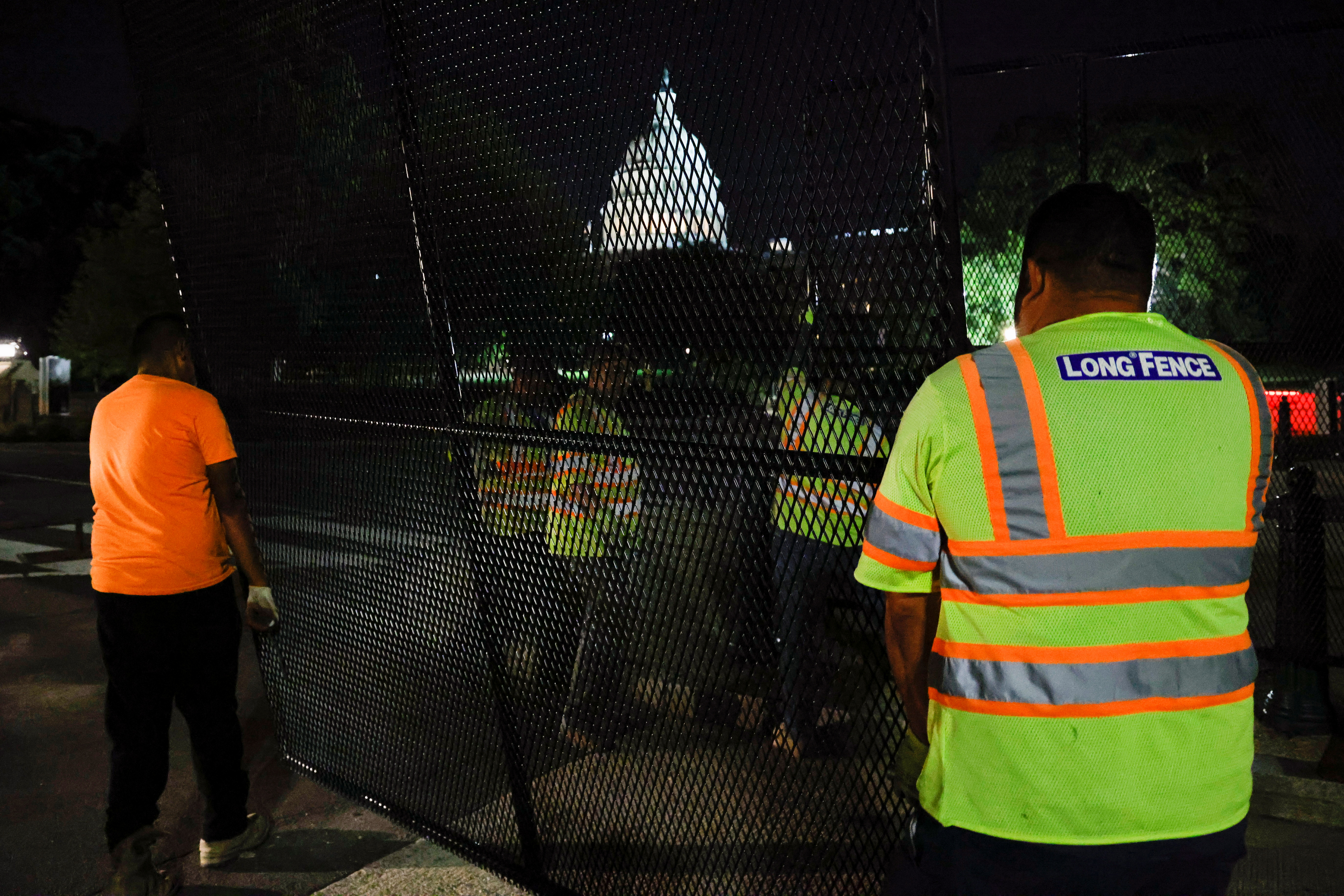 Workers install a security fence around the U.S. Capitol ahead of an expected rally on Saturday in support of the Jan. 6 defendants in Washington, U.S., September 15, 2021. REUTERS/Jonathan Ernst