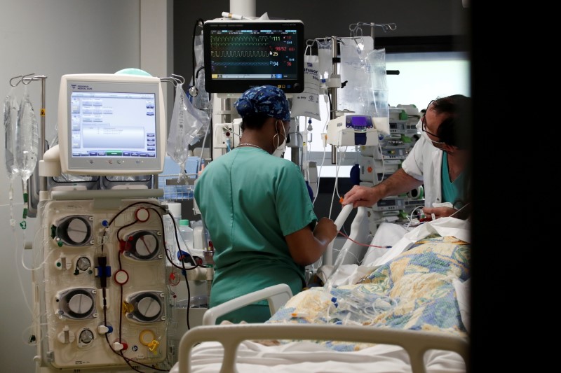 Healthcare workers adjust medical equipment in the Intensive Care Unit (ICU) at the Centre Cardiologique du Nord private hospital in Saint-Denis, near Paris, amid the coronavirus disease (COVID-19) pandemic in France, May 4, 2021. REUTERS/Benoit Tessier