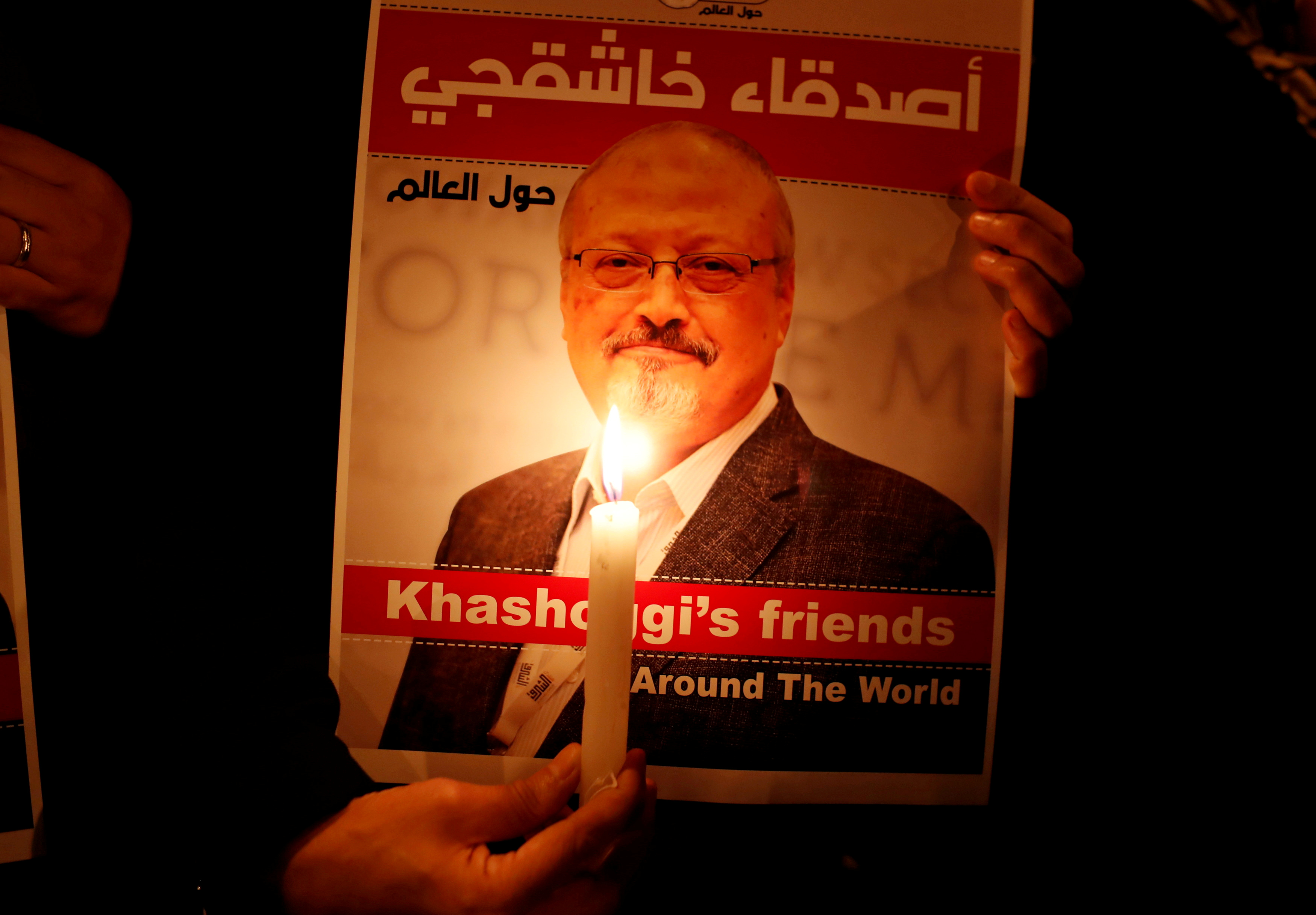 A demonstrator holds a poster with a picture of Saudi journalist Jamal Khashoggi outside the Saudi Arabia consulate in Istanbul, Turkey October 25, 2018. REUTERS/Osman Orsal